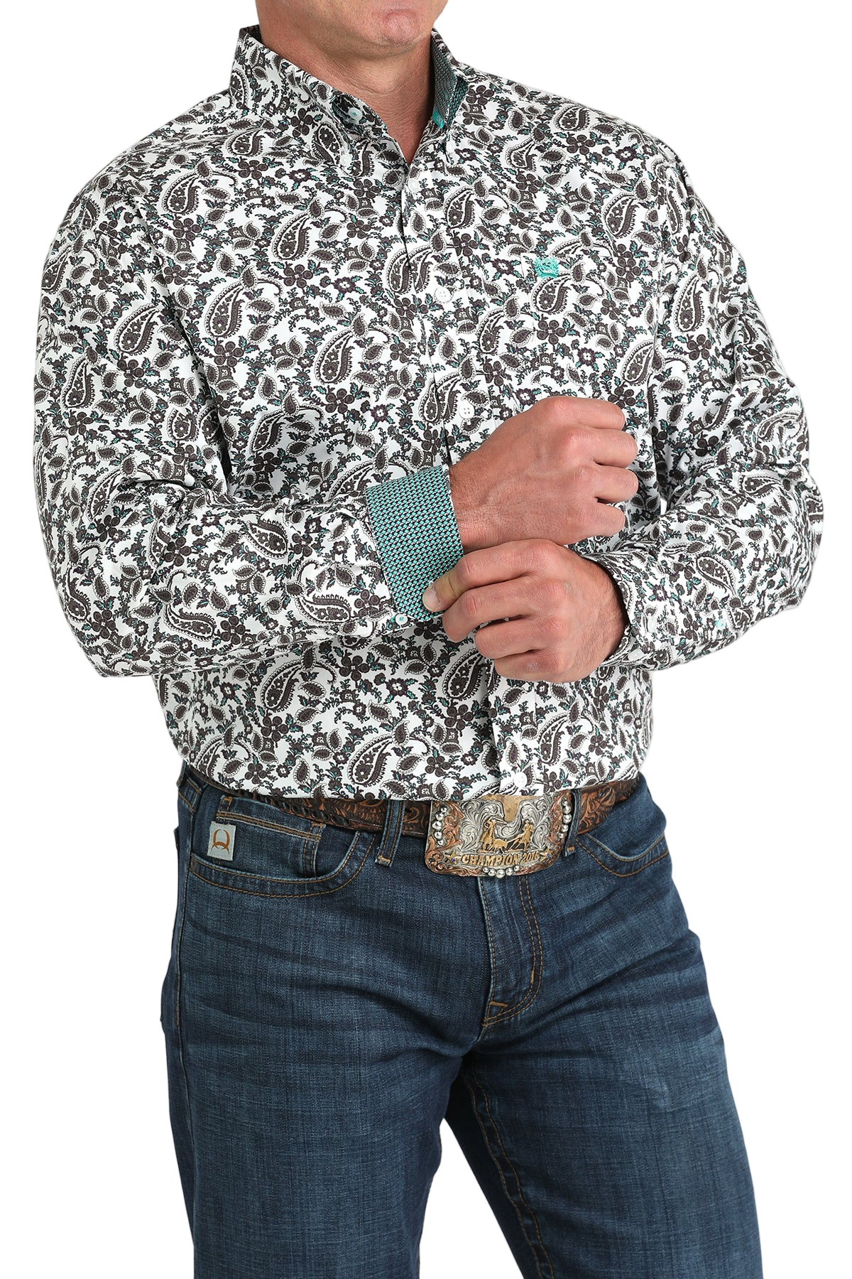 Man wearing a patterned multi-color long sleeve button-down shirt with contrasting cuffs and jeans on a transparent background