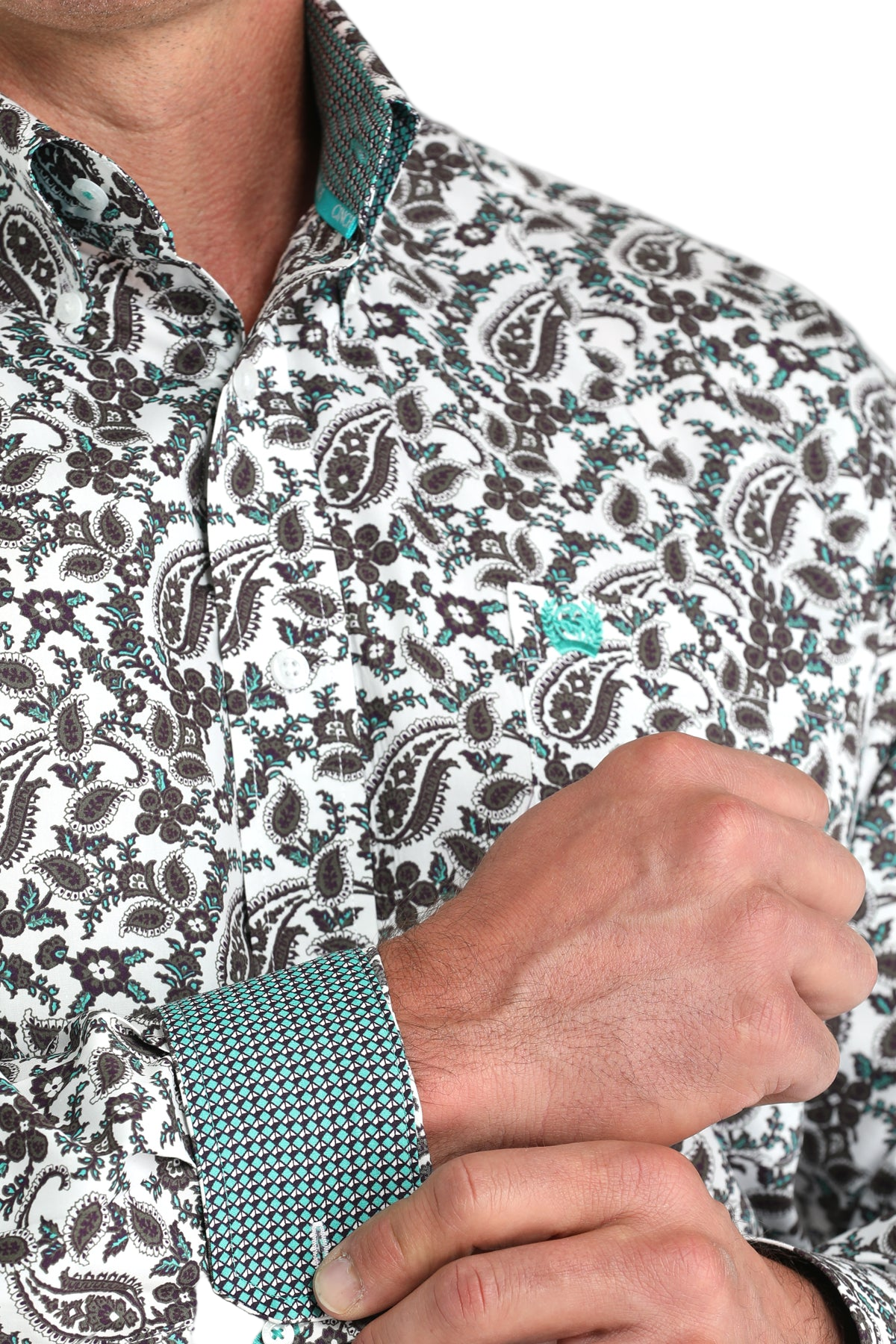 Close-up of a man wearing a patterned multi-color long sleeve button-down shirt with contrasting cuffs on a transparent background
