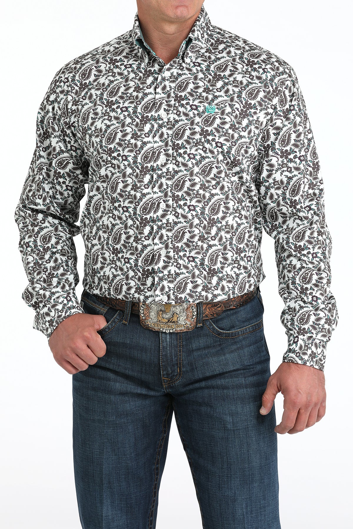 Man wearing a patterned shirt and jeans on a white background