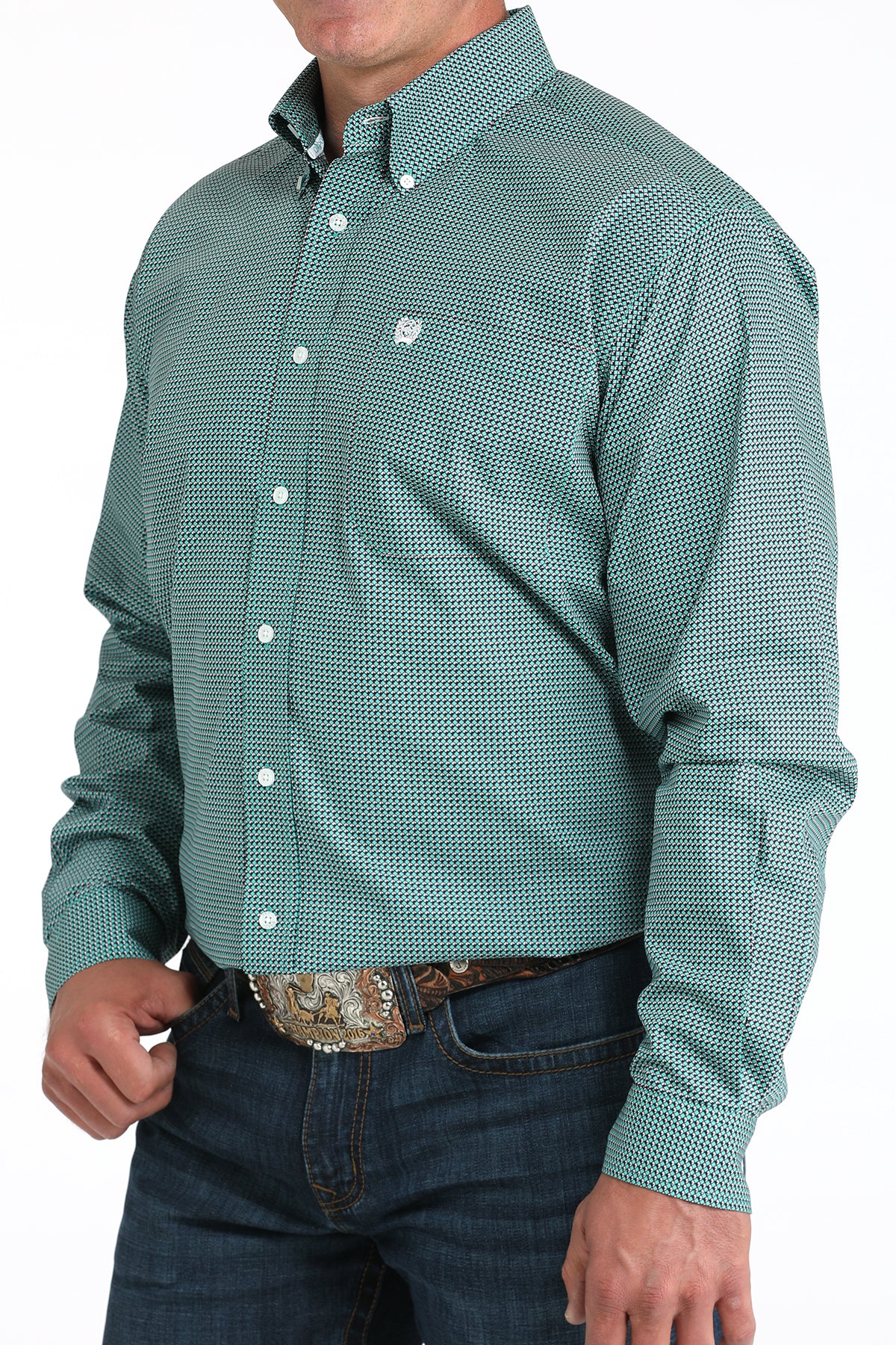 Man wearing a teal long sleeve button-down shirt with jeans and a belt
