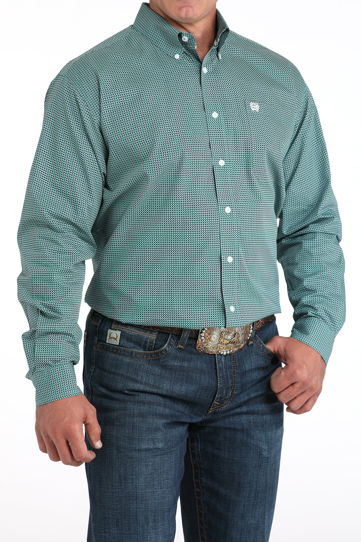 Man wearing a teal long sleeve button-down shirt with jeans and a belt