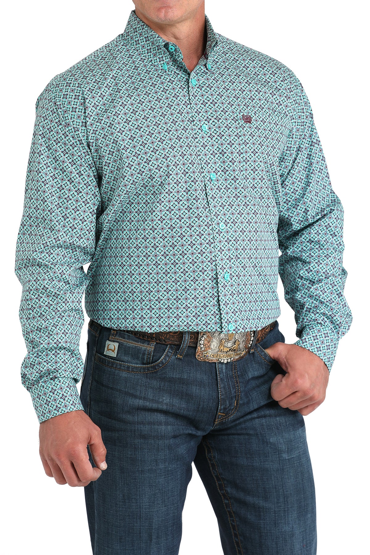Man wearing a teal long sleeve button-down shirt with jeans and a belt