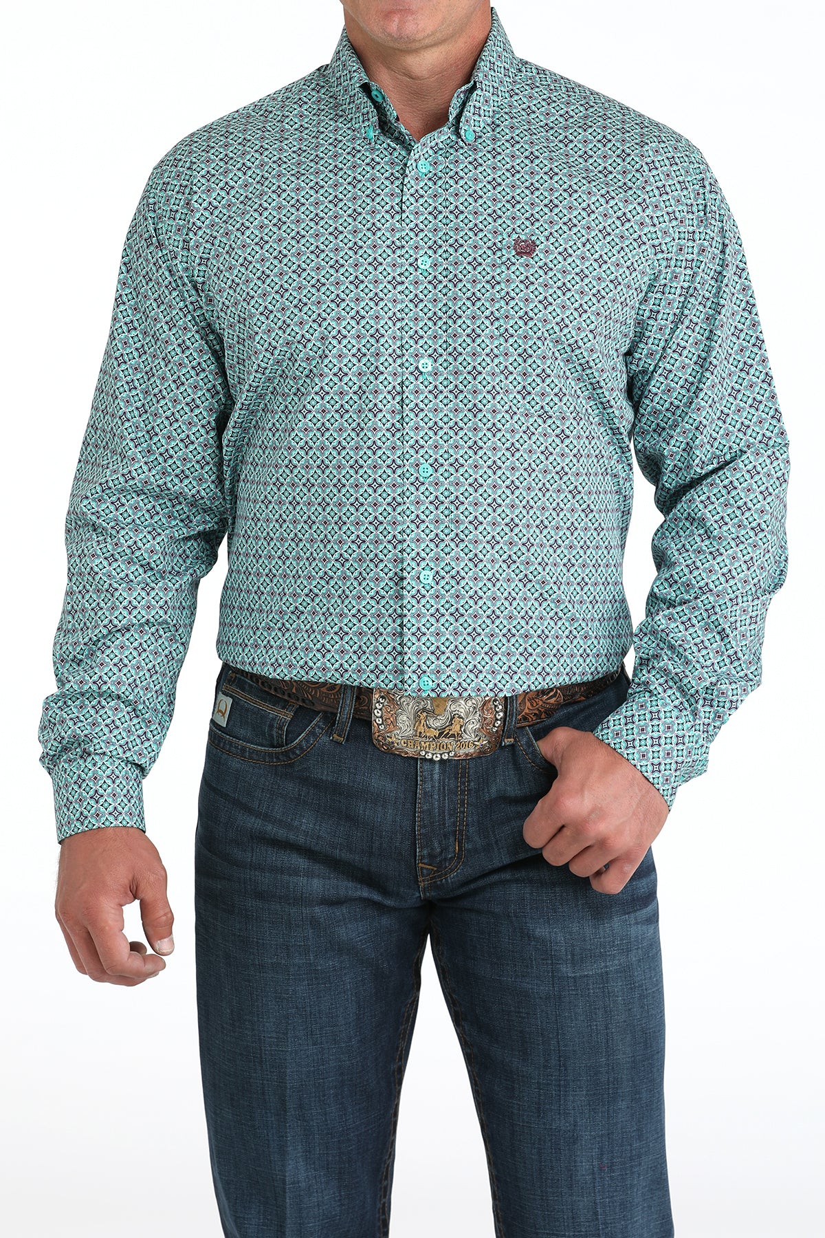 Man wearing a teal long sleeve button-down shirt with jeans and a belt