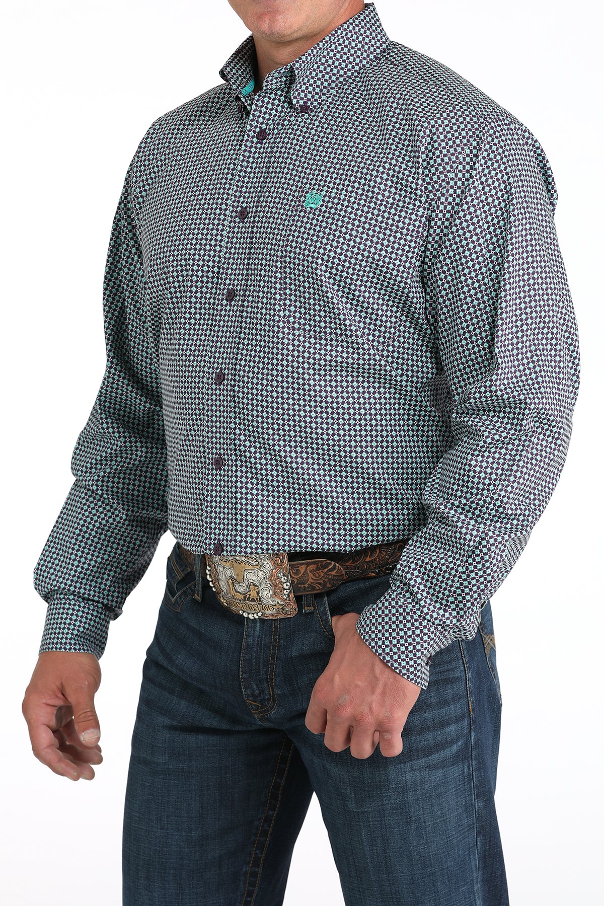 Man wearing a purple long sleeve button-down shirt with jeans and a belt