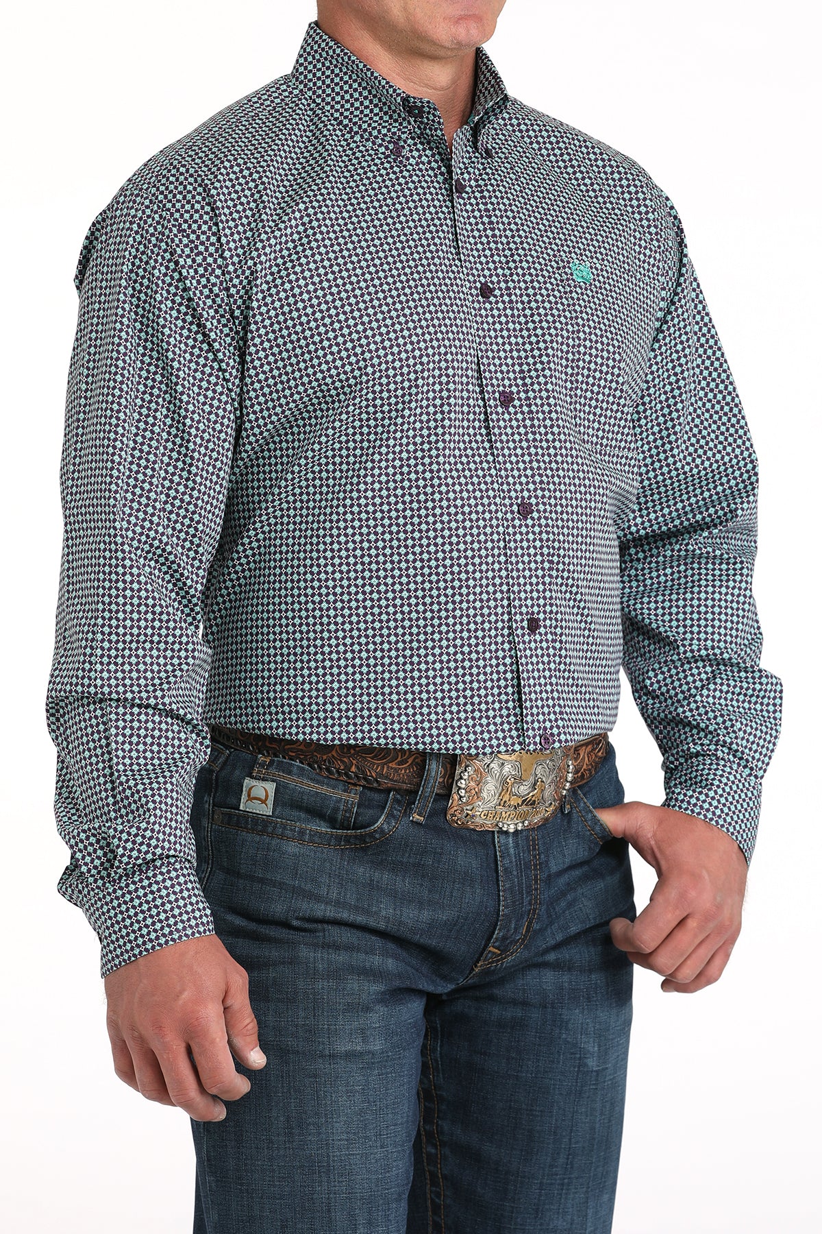 Man wearing a purple long sleeve button-down shirt with jeans and a belt