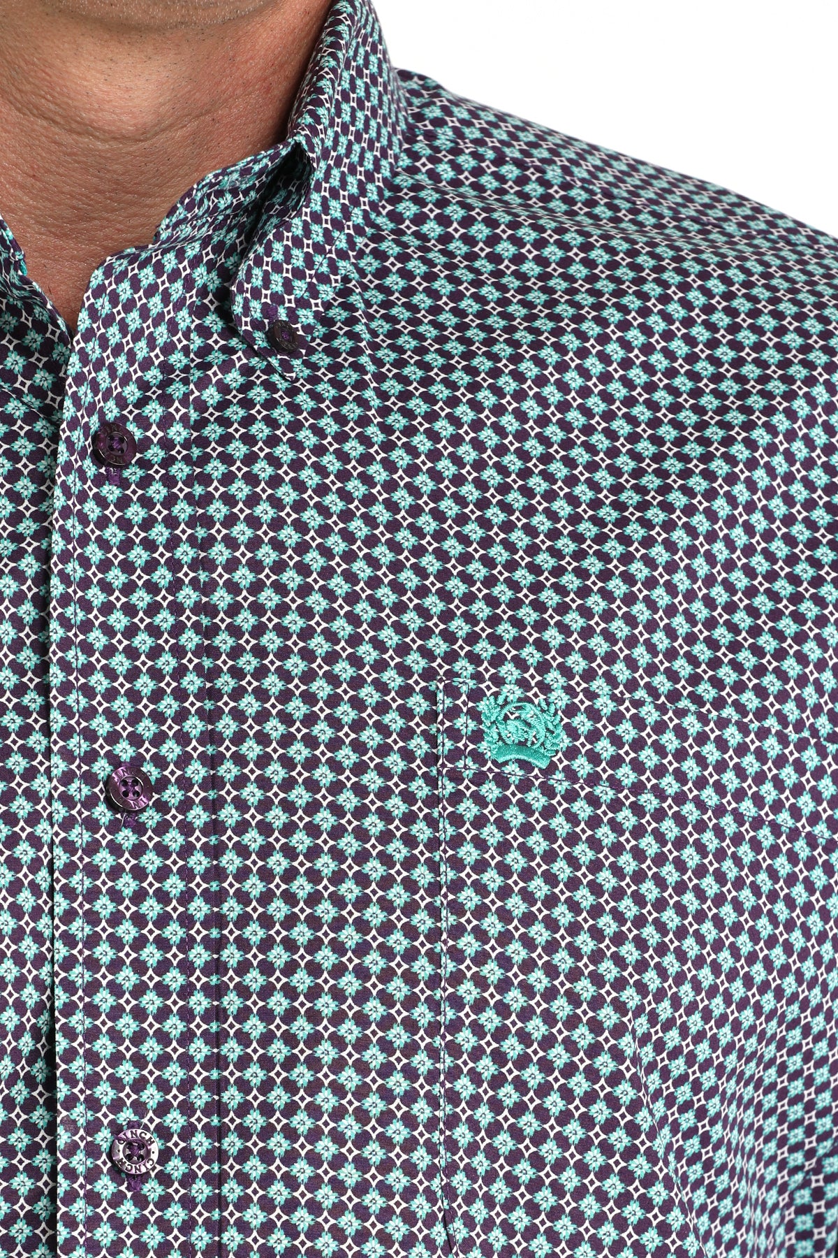 Close-up of a man wearing a purple long sleeve button-down shirt