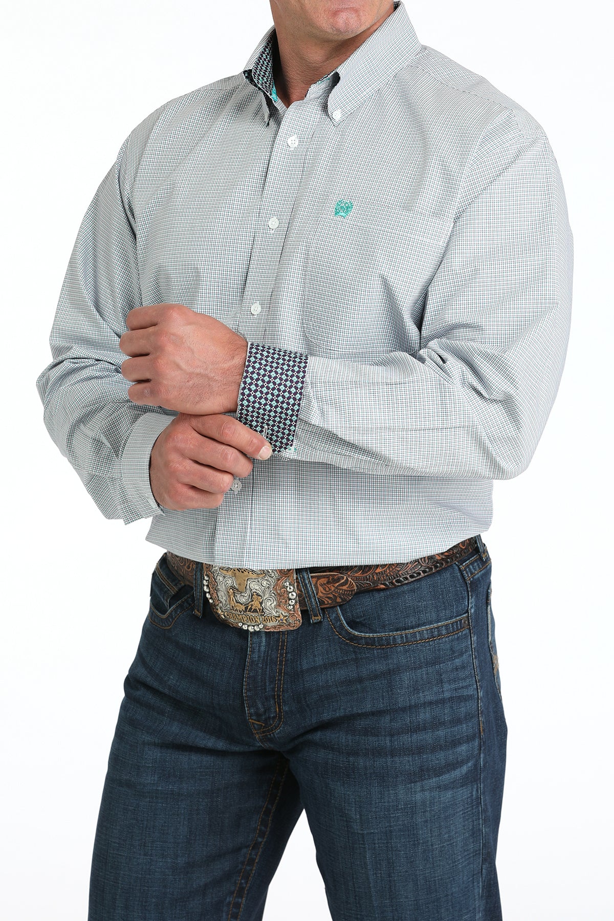 Man wearing a white plaid long sleeve button-down shirt with contrasting cuffs, paired with jeans and a belt