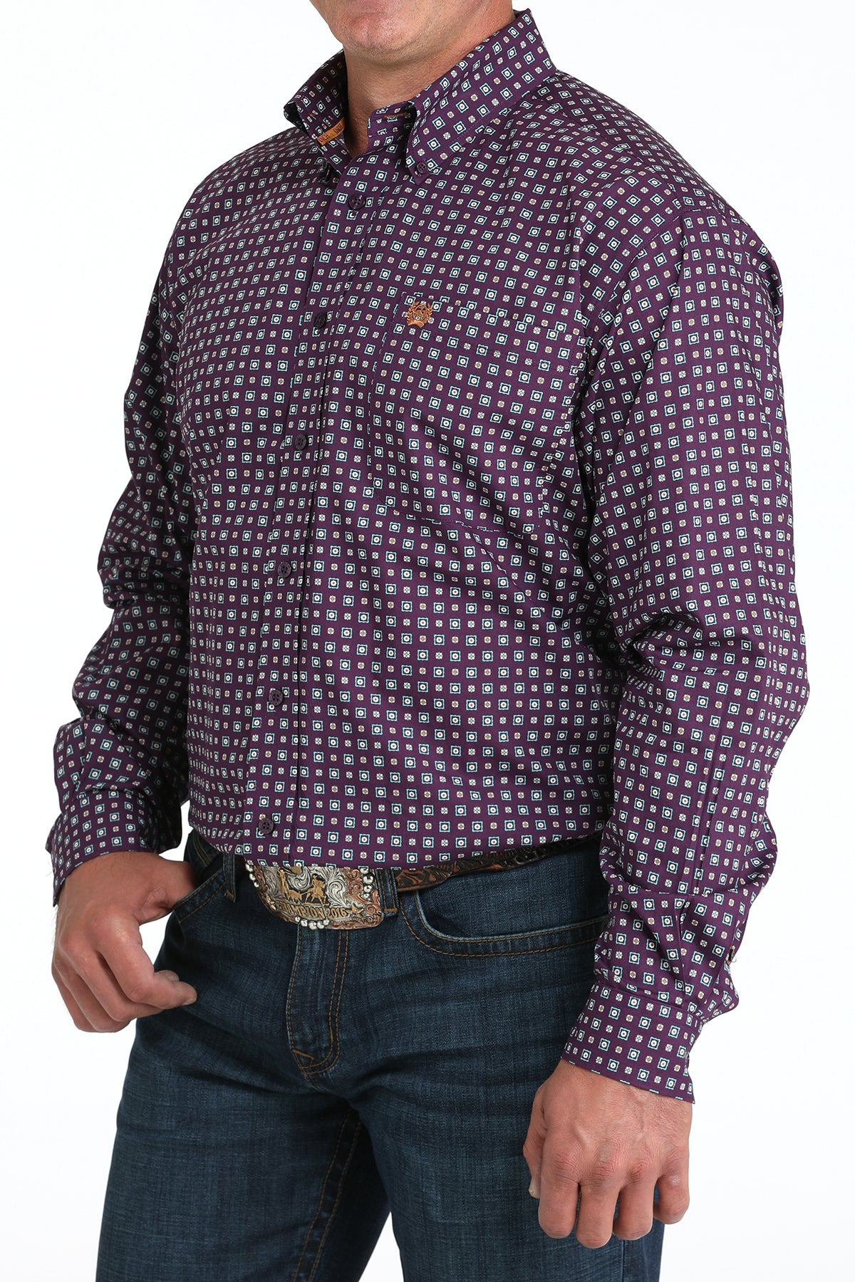 Man wearing a checkered purple long sleeve button-down shirt with jeans and a belt