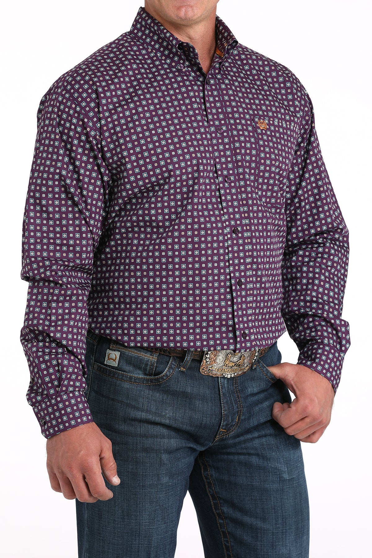 Man wearing a checkered purple long sleeve button-down shirt with jeans and a belt