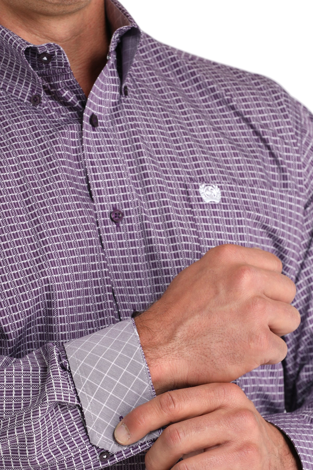 Close-up of a man wearing a patterned purple long sleeve button-down shirt with contrasting cuffs on a transparent background