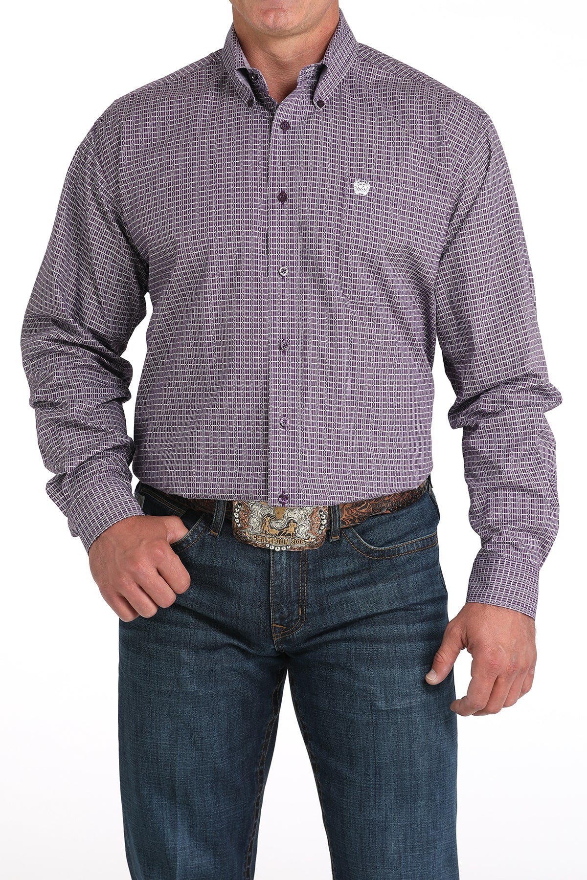 Man wearing a purple long sleeve button-down shirt with jeans and a belt