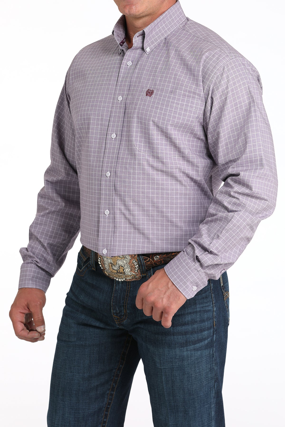 Man wearing a plaid purple long sleeve button-down shirt with jeans and a belt