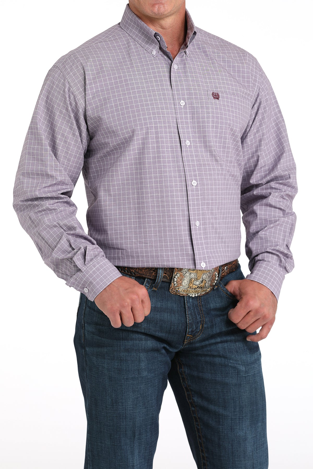 Man wearing a plaid purple long sleeve button-down shirt with jeans and a belt
