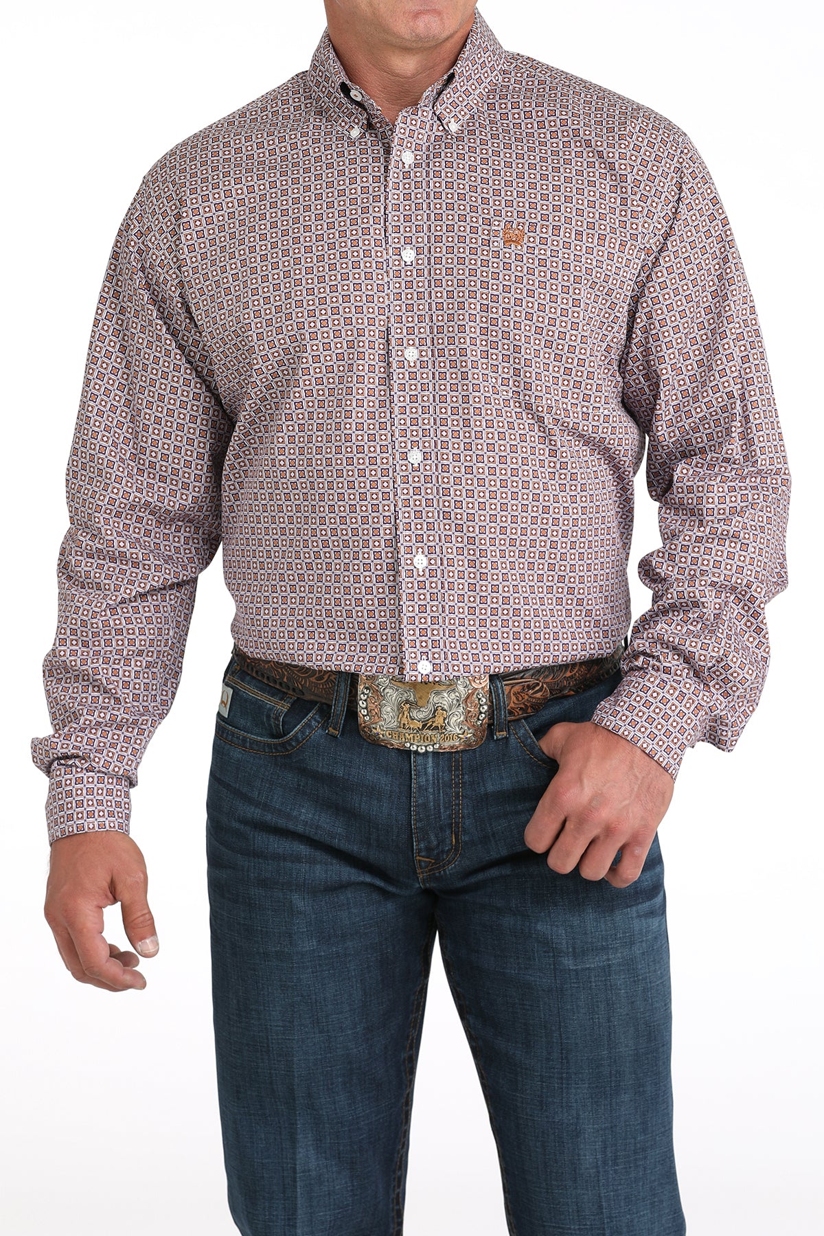 Man wearing a patterned purple long sleeve button-down shirt with jeans and a belt