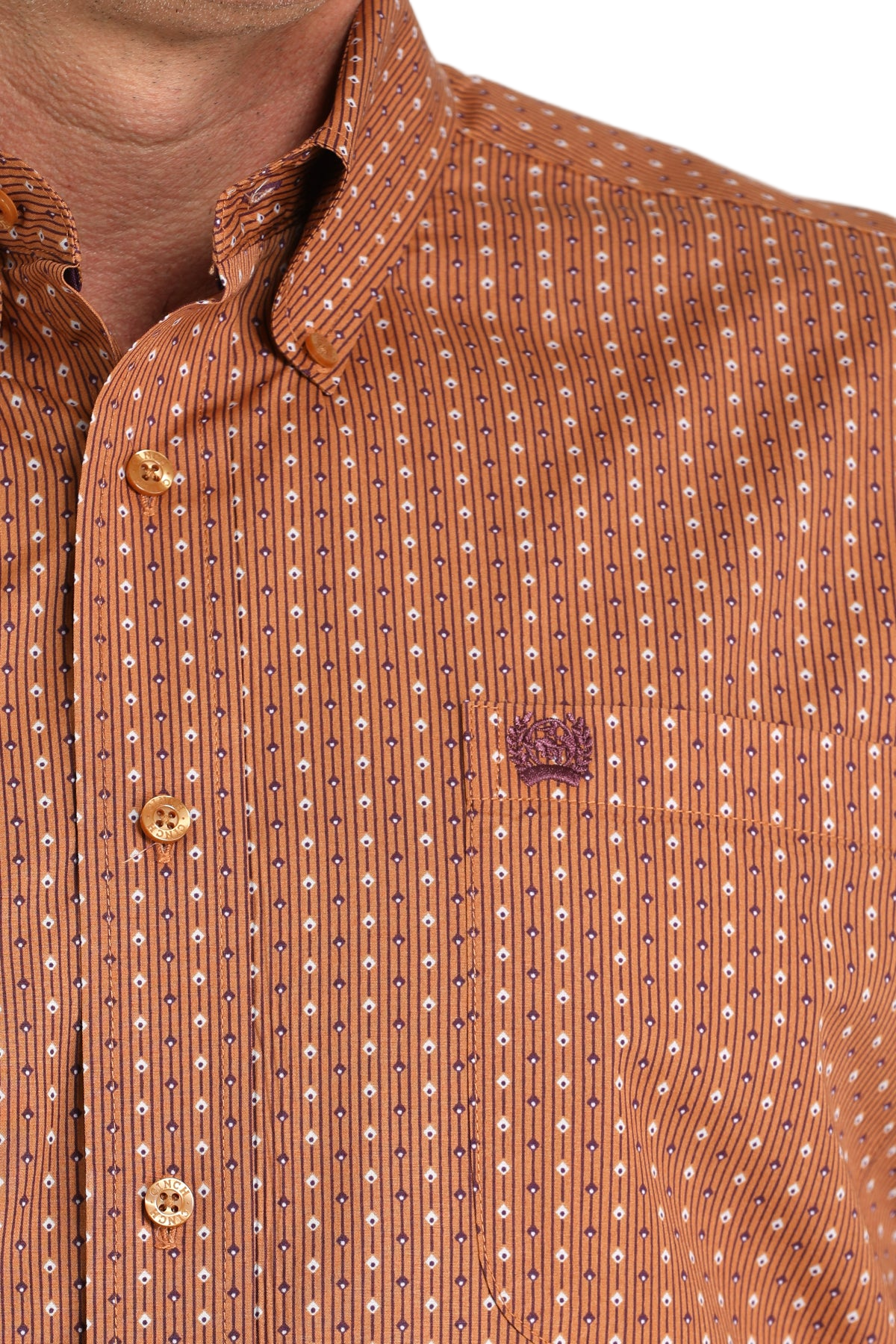 Close-up of a man wearing a patterned orange long sleeve button-down shirt on a transparent background