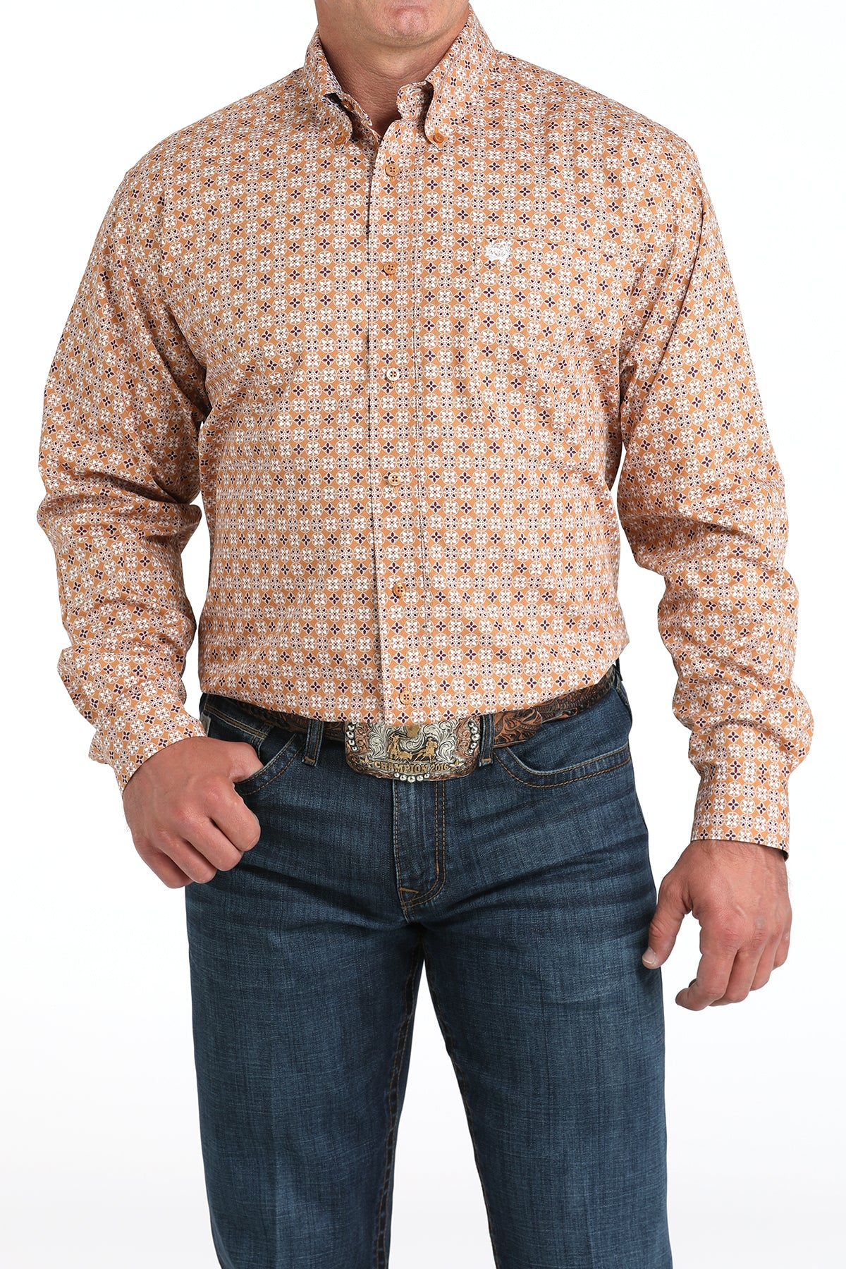 Man wearing a long sleeve button-down shirt that is brown and has a pattern, paired with jeans and a belt