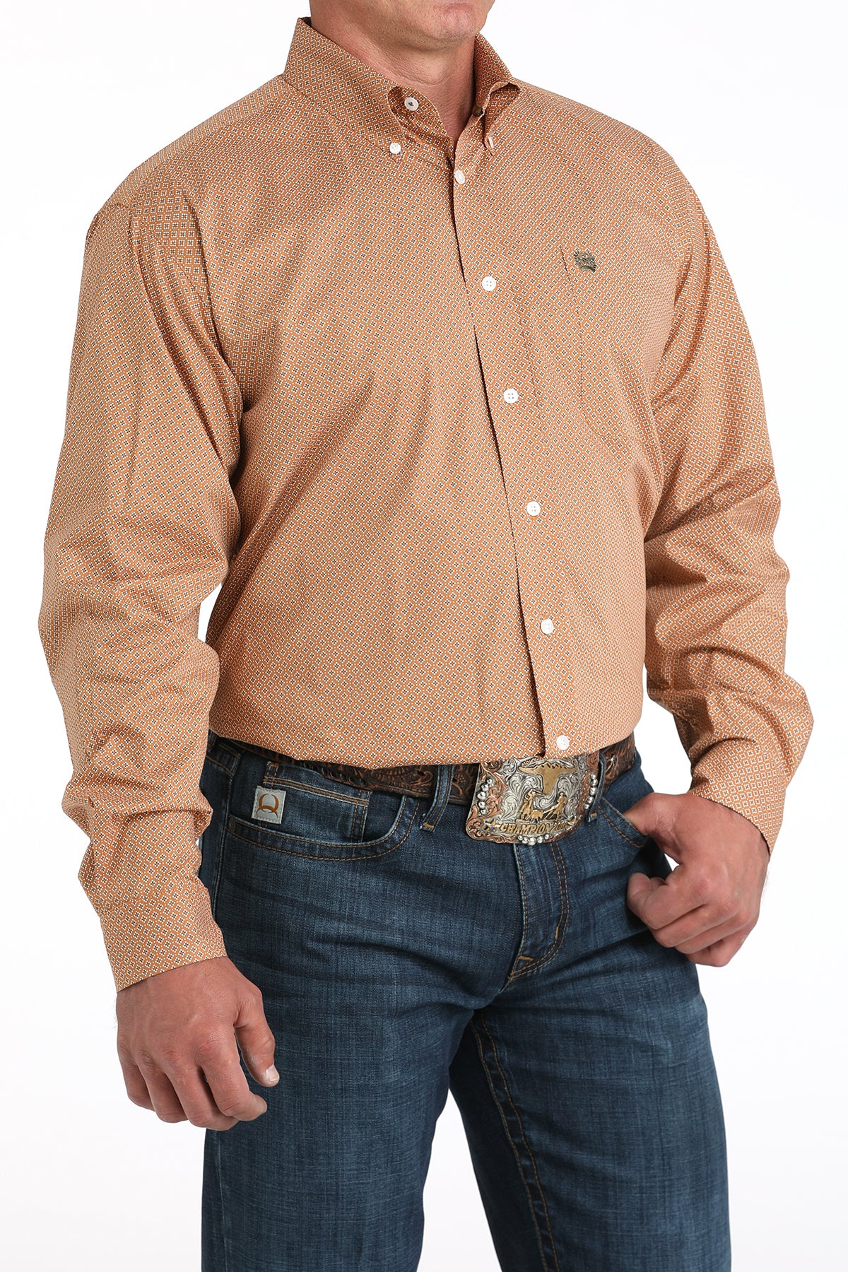 Man wearing a brown long sleeve button-down with jeans and a belt