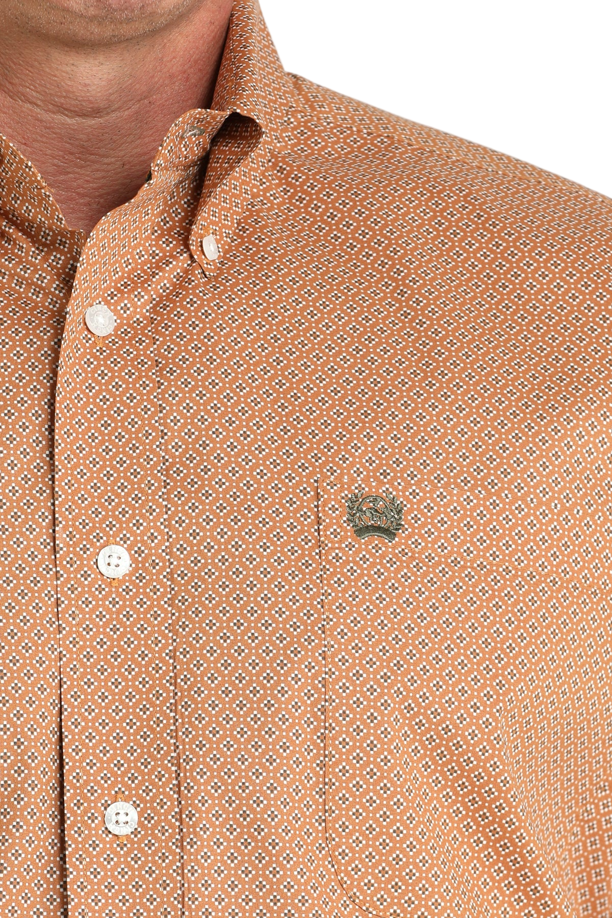 Close-up of a man wearing a patterned orange long sleeve button-down shirt on a transparent background
