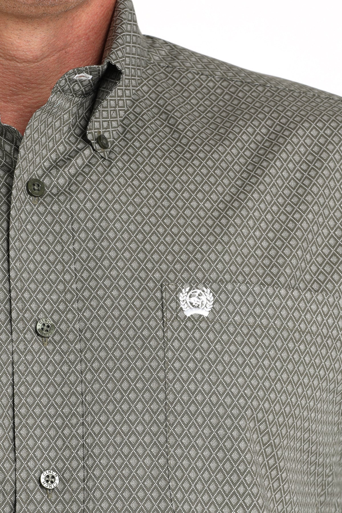 Close-up of a man wearing a green long sleeve button-down