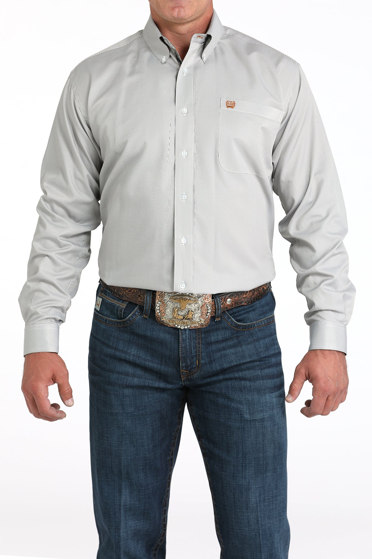 Man wearing a white long sleeve button-down with jeans and a belt