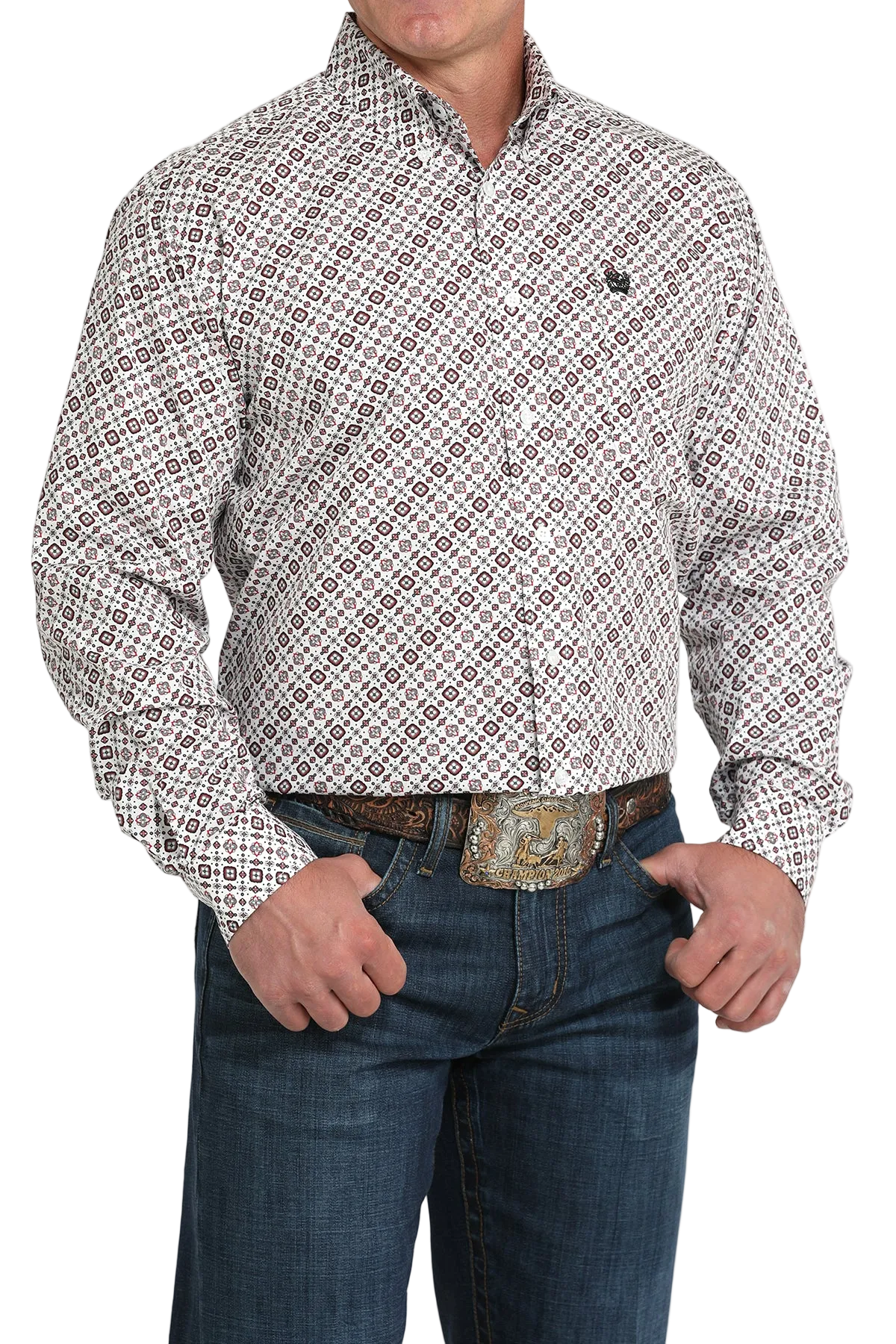A man wearing a light patterned button-up shirt, dark jeans, and a large belt buckle, standing against a transparent background