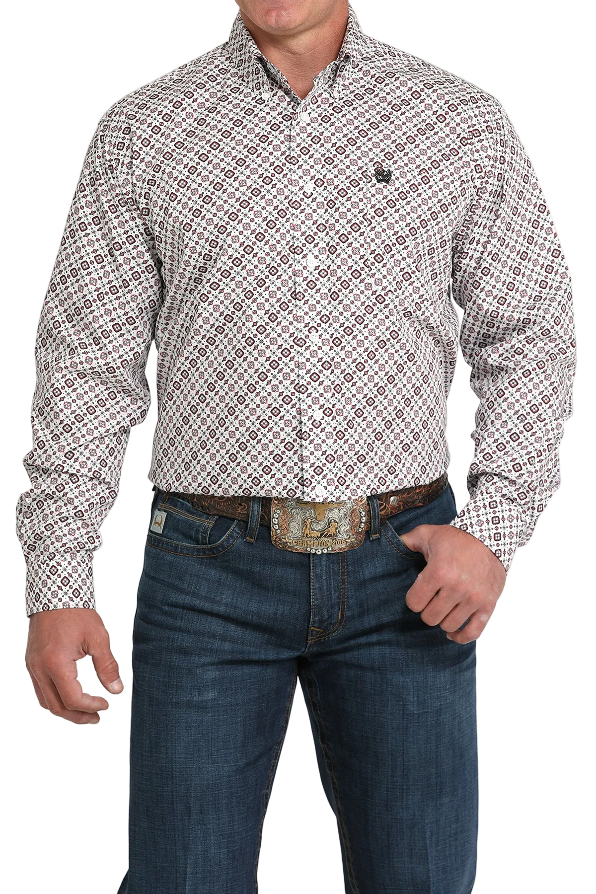 A man wearing a light patterned button-up shirt, dark jeans, and a large belt buckle, standing against a transparent background