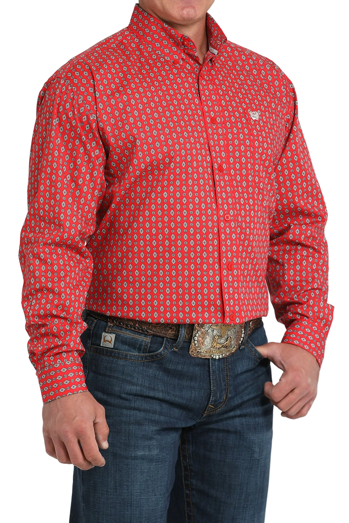 A man wearing a red patterned button-up shirt, dark jeans, and a large belt buckle, standing against a transparent background