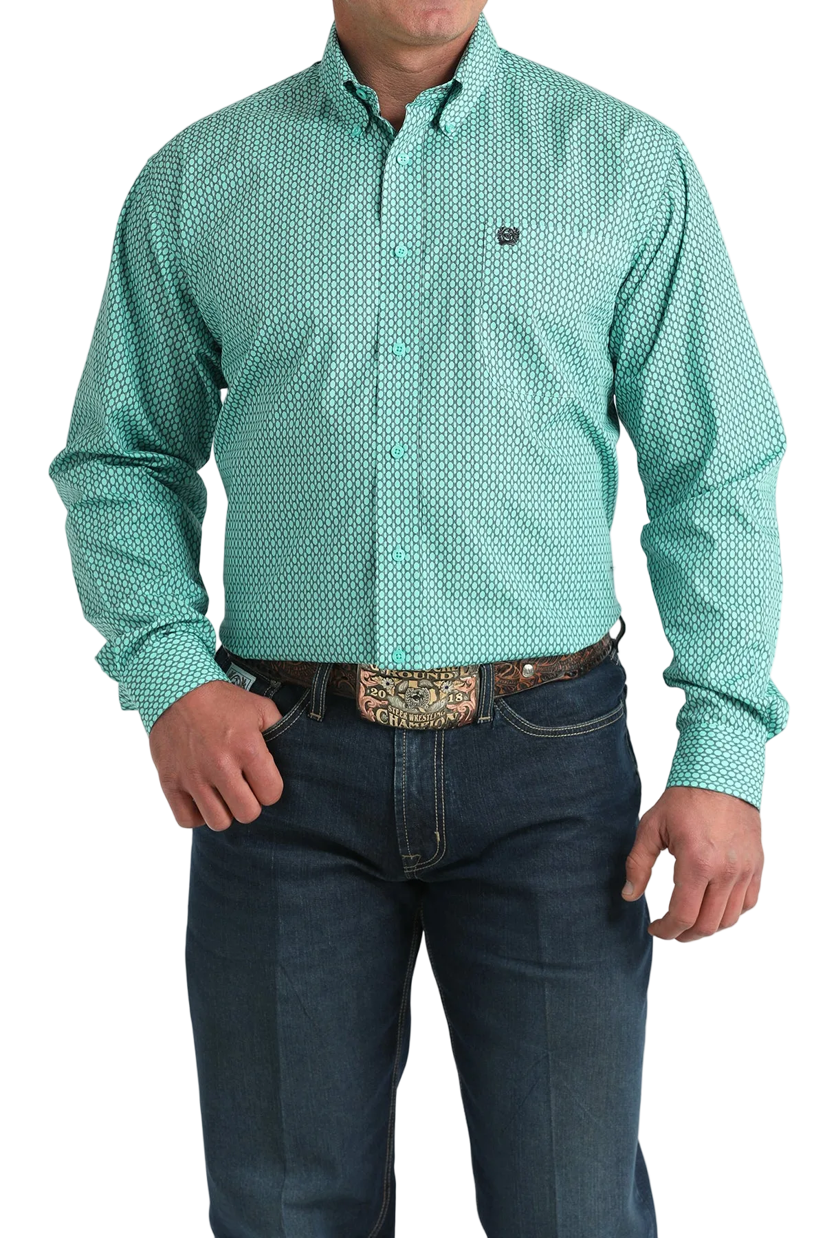 Man wearing a green patterned shirt and dark jeans on a white background