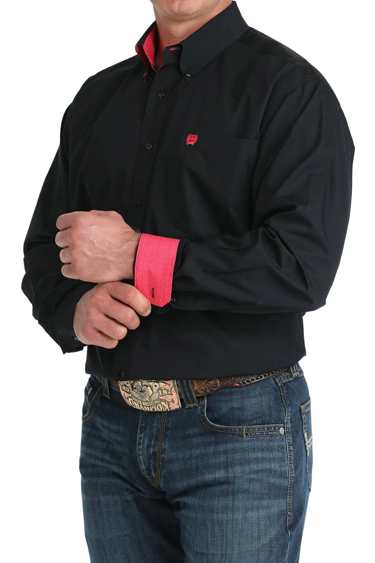 Person wearing a black long-sleeve shirt with a red collar and pink cuffs, paired with blue jeans.
