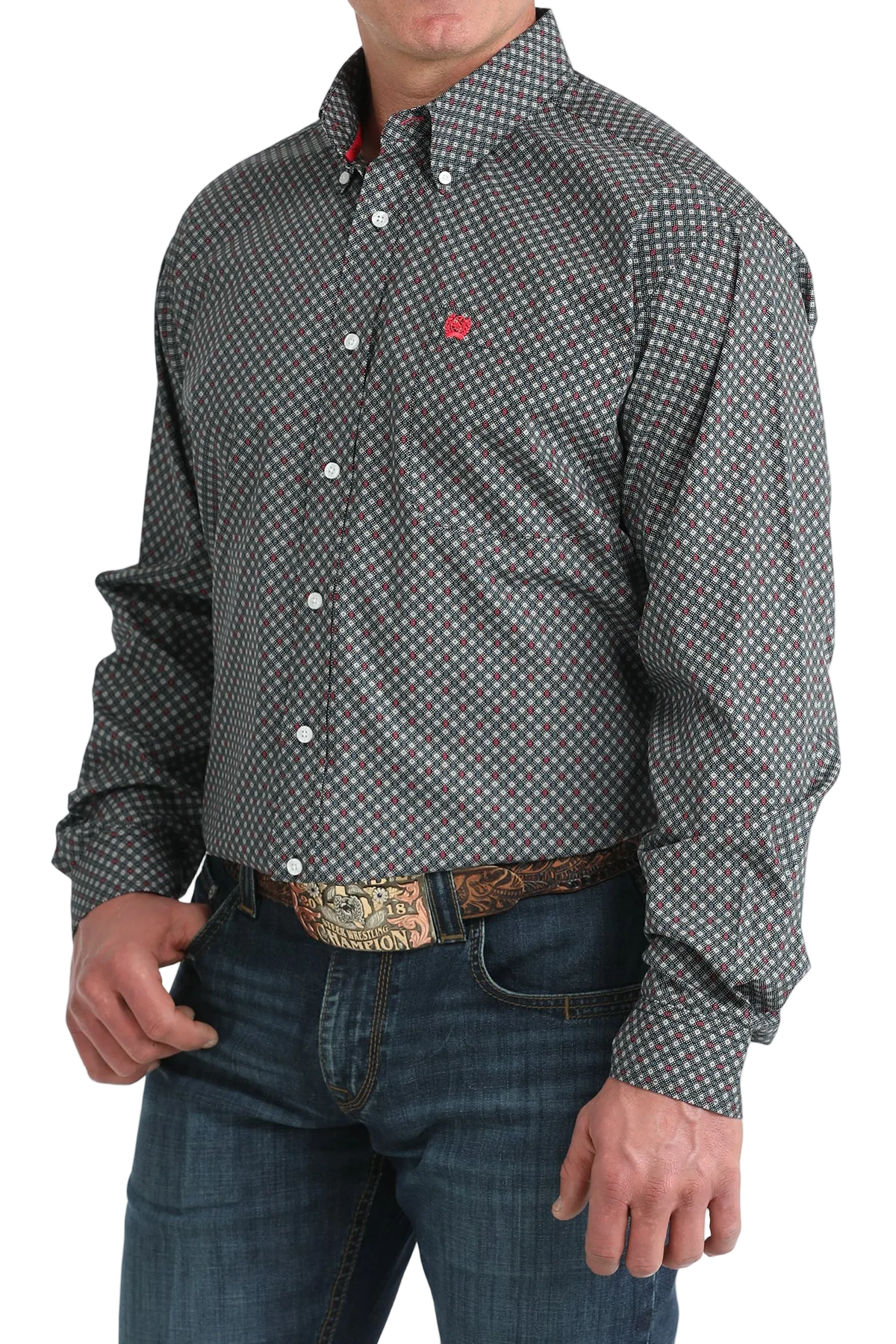 Man wearing a patterned shirt and jeans with a belt.