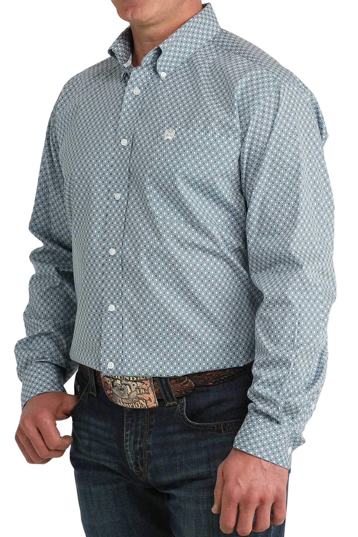 Man wearing a patterned button-up shirt and jeans on a white background