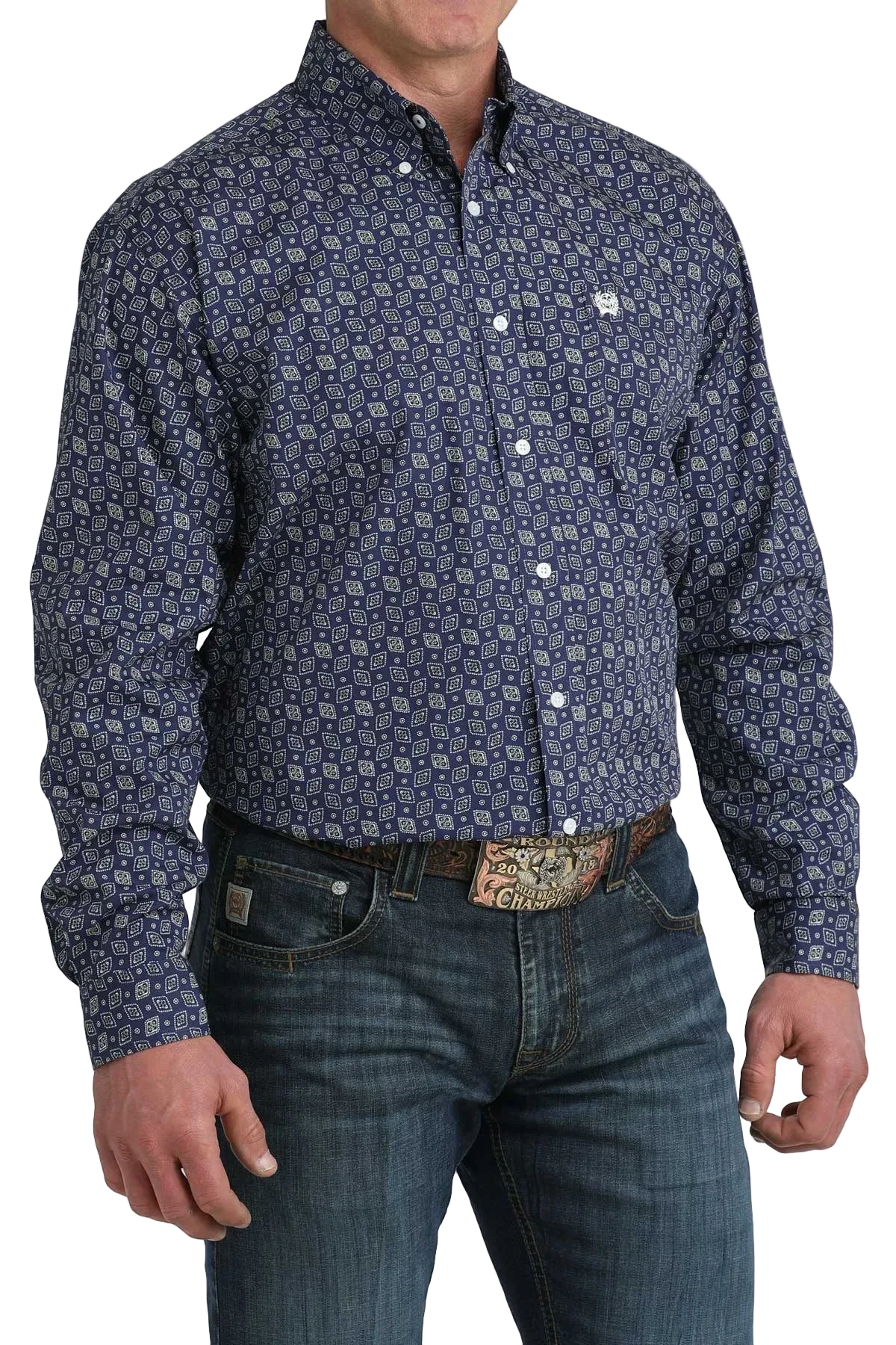 Man wearing a patterned navy shirt and jeans on a white background