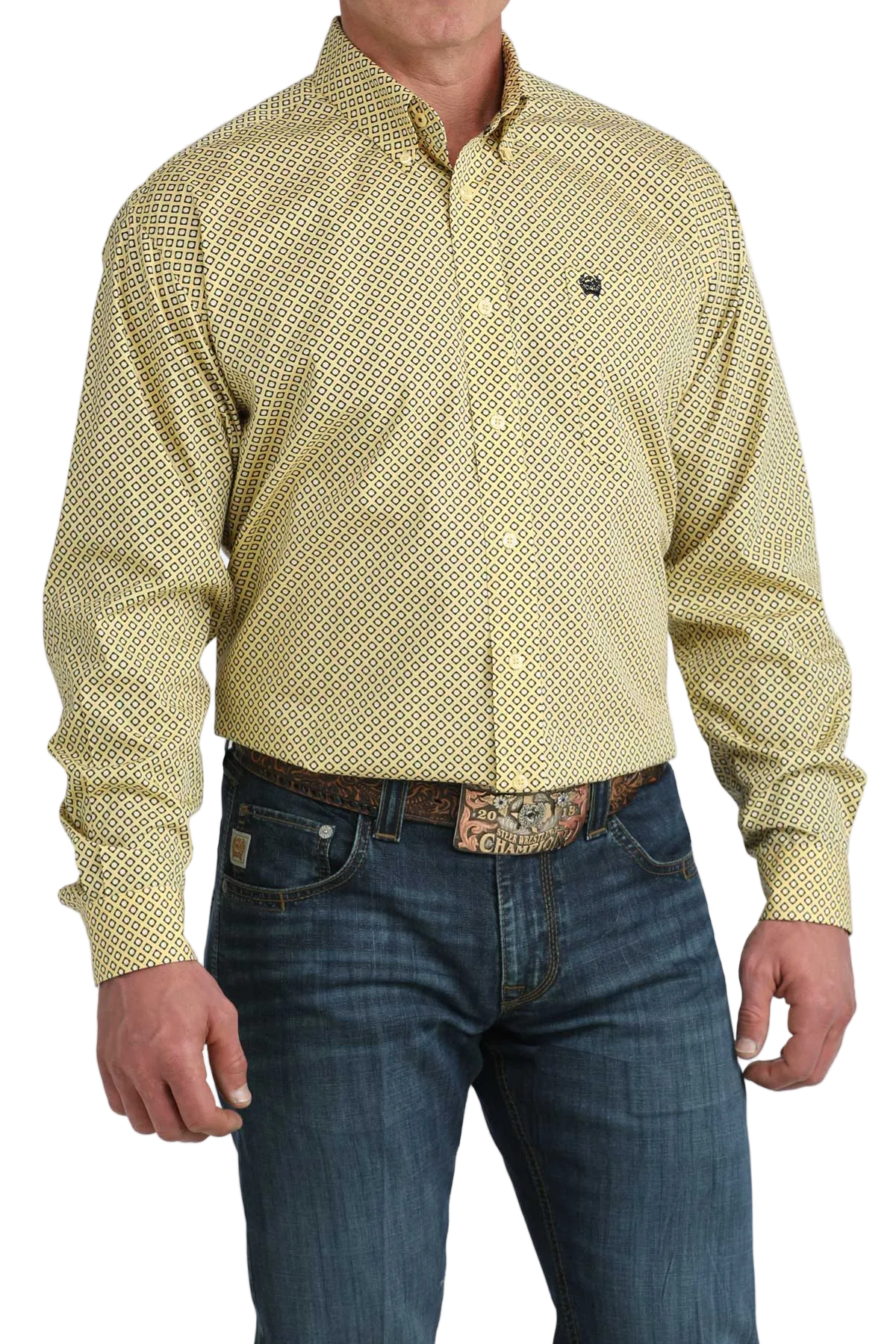 Man wearing a yellow patterned shirt and blue jeans on a white background