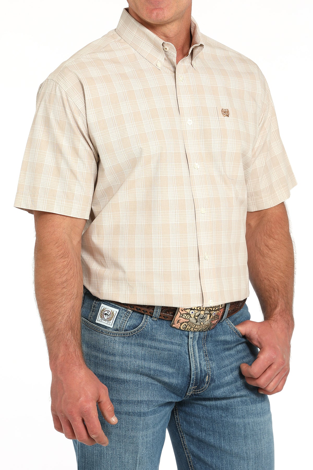 Man wearing a beige checkered shirt and blue jeans on a white background