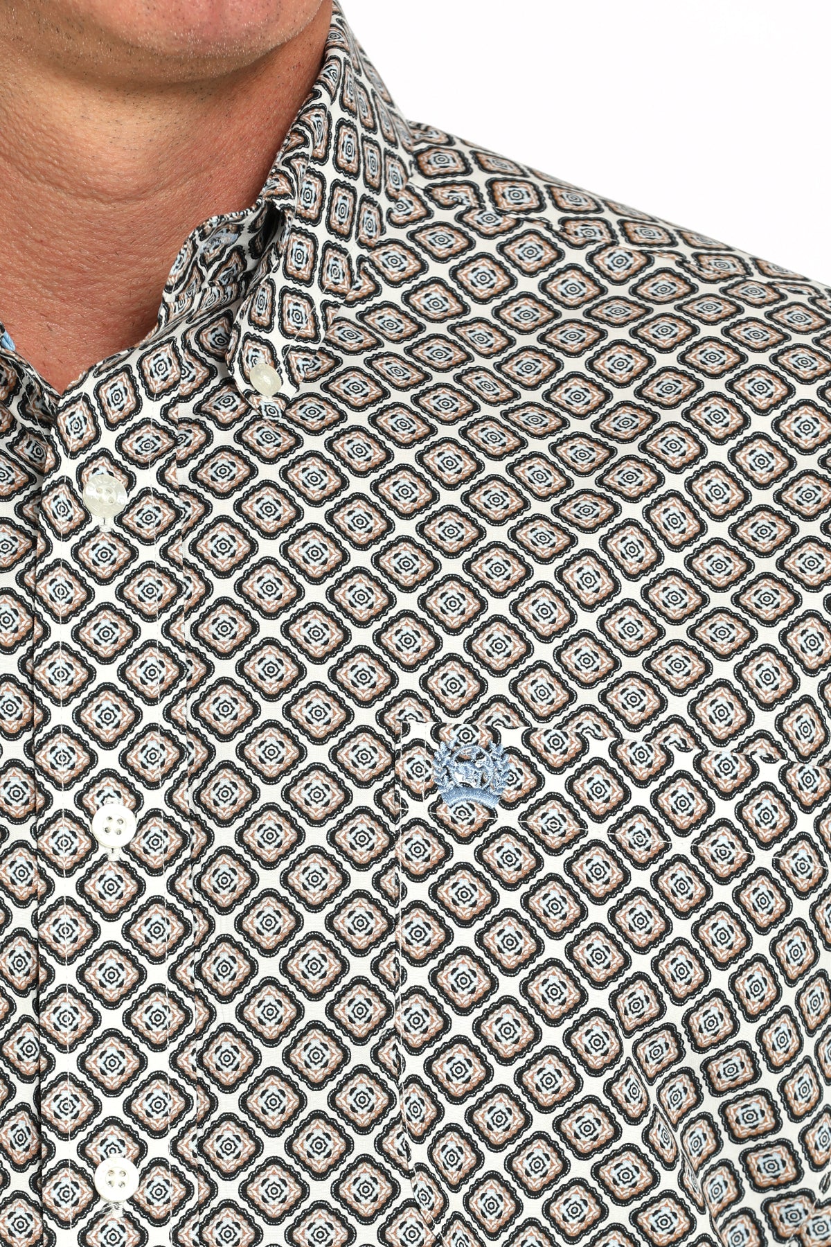 Close-up of a man wearing a patterned short sleeve button-down