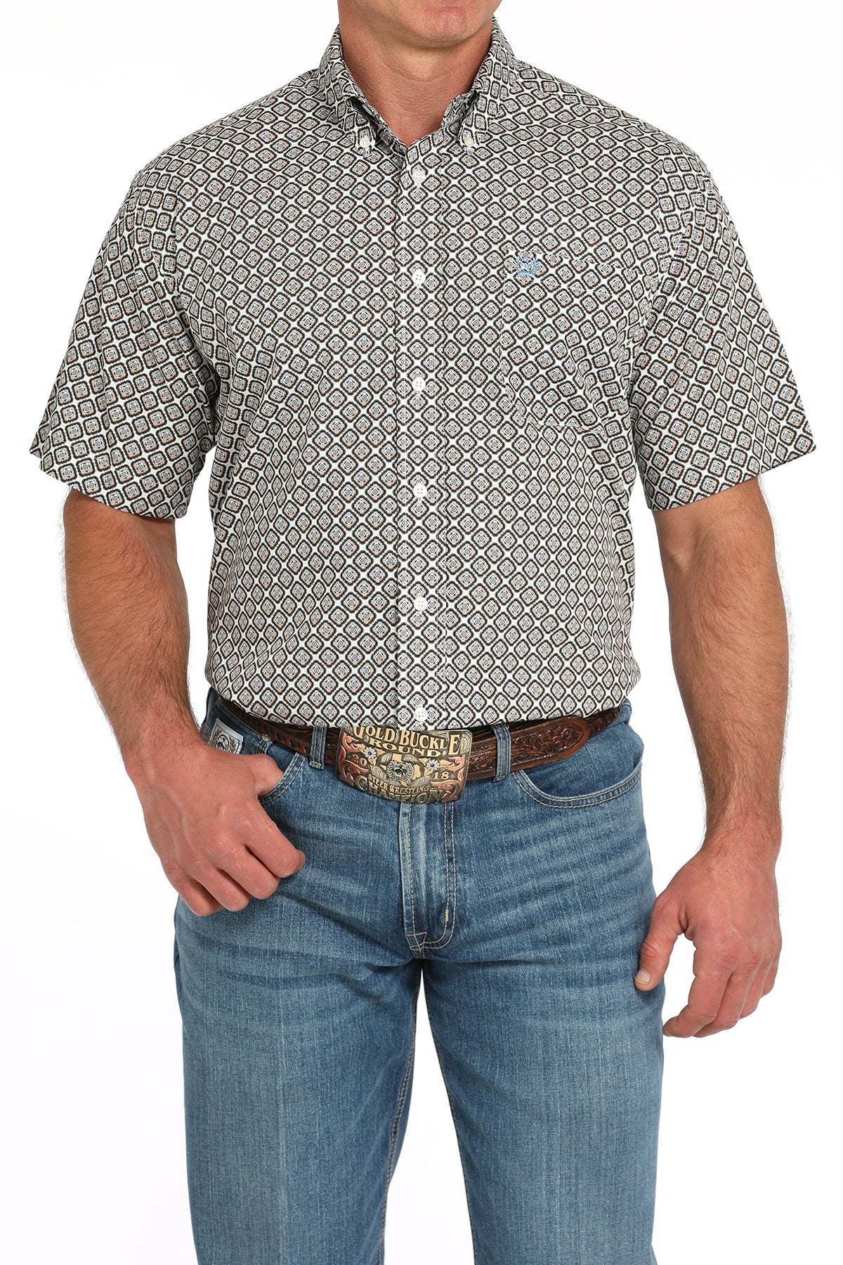 Man wearing a patterned short sleeve button-down with jeans and a belt