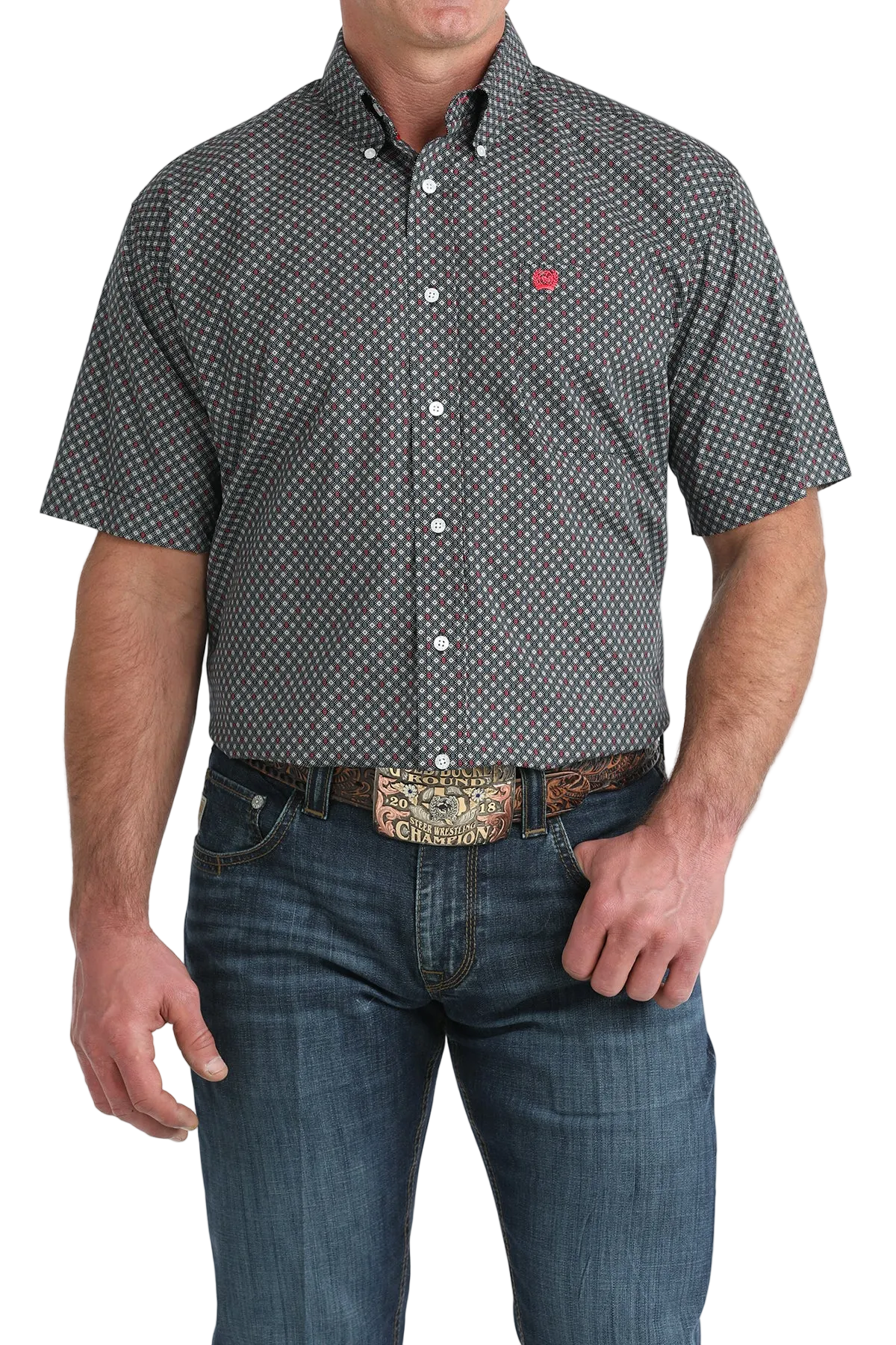 Man wearing a patterned button-up shirt and jeans with a belt buckle.