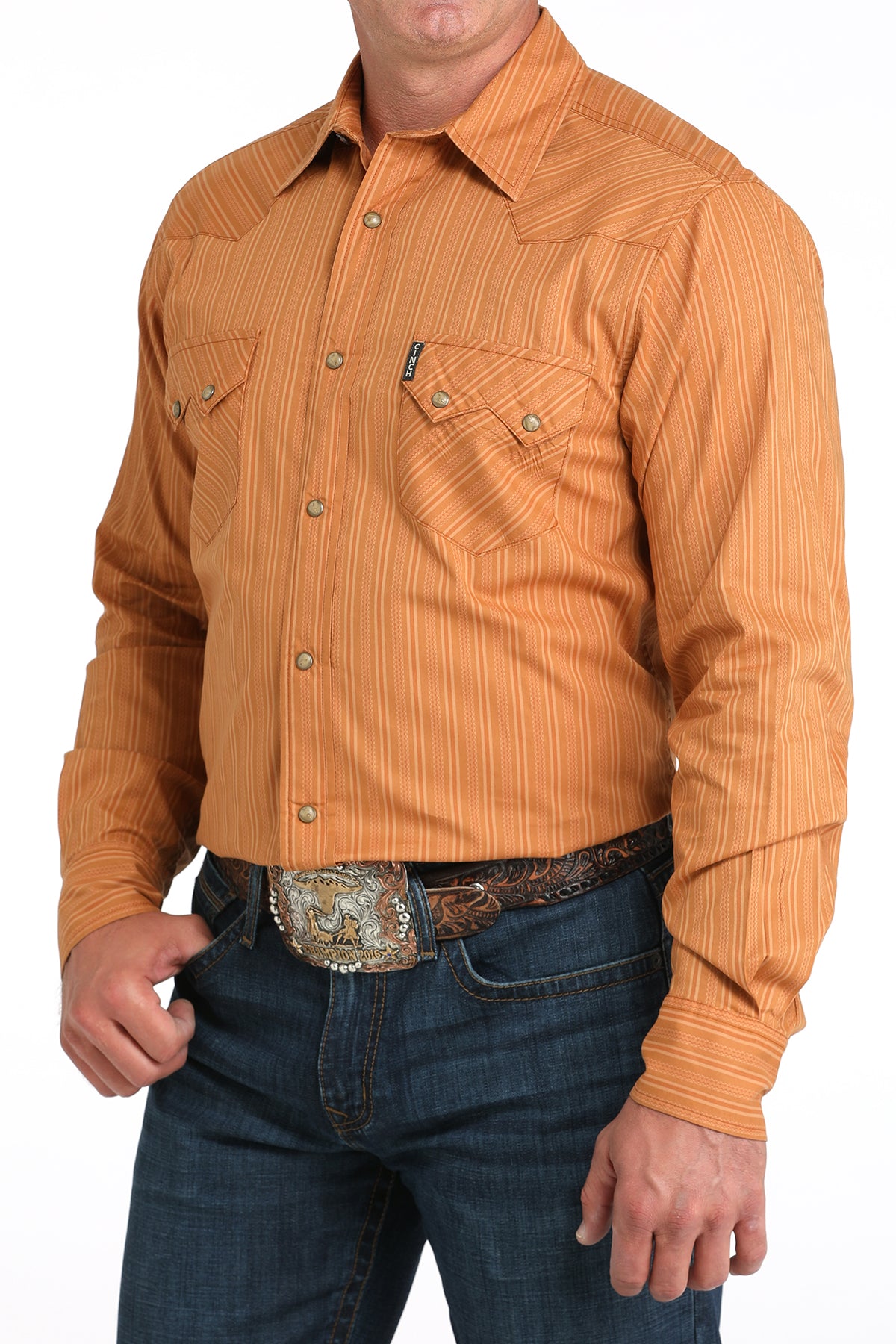 Man wearing an orange striped shirt and blue jeans on a white background