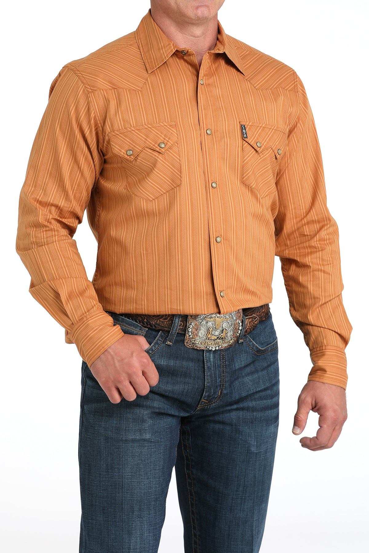 Man wearing a brown striped shirt and blue jeans with a white background