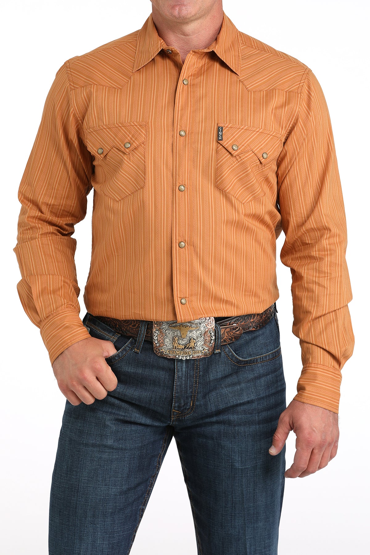 Orange button-up shirt with blue jeans on a white background