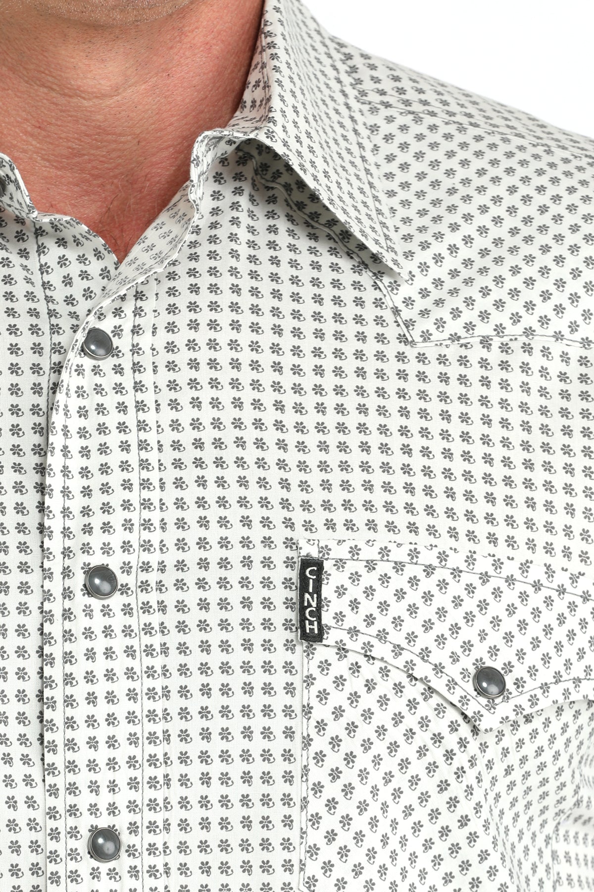 Close-up of a patterned shirt with a visible brand logo.