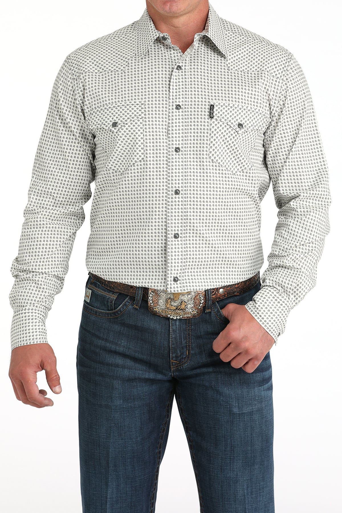 Man wearing a patterned white shirt and blue jeans on a white background