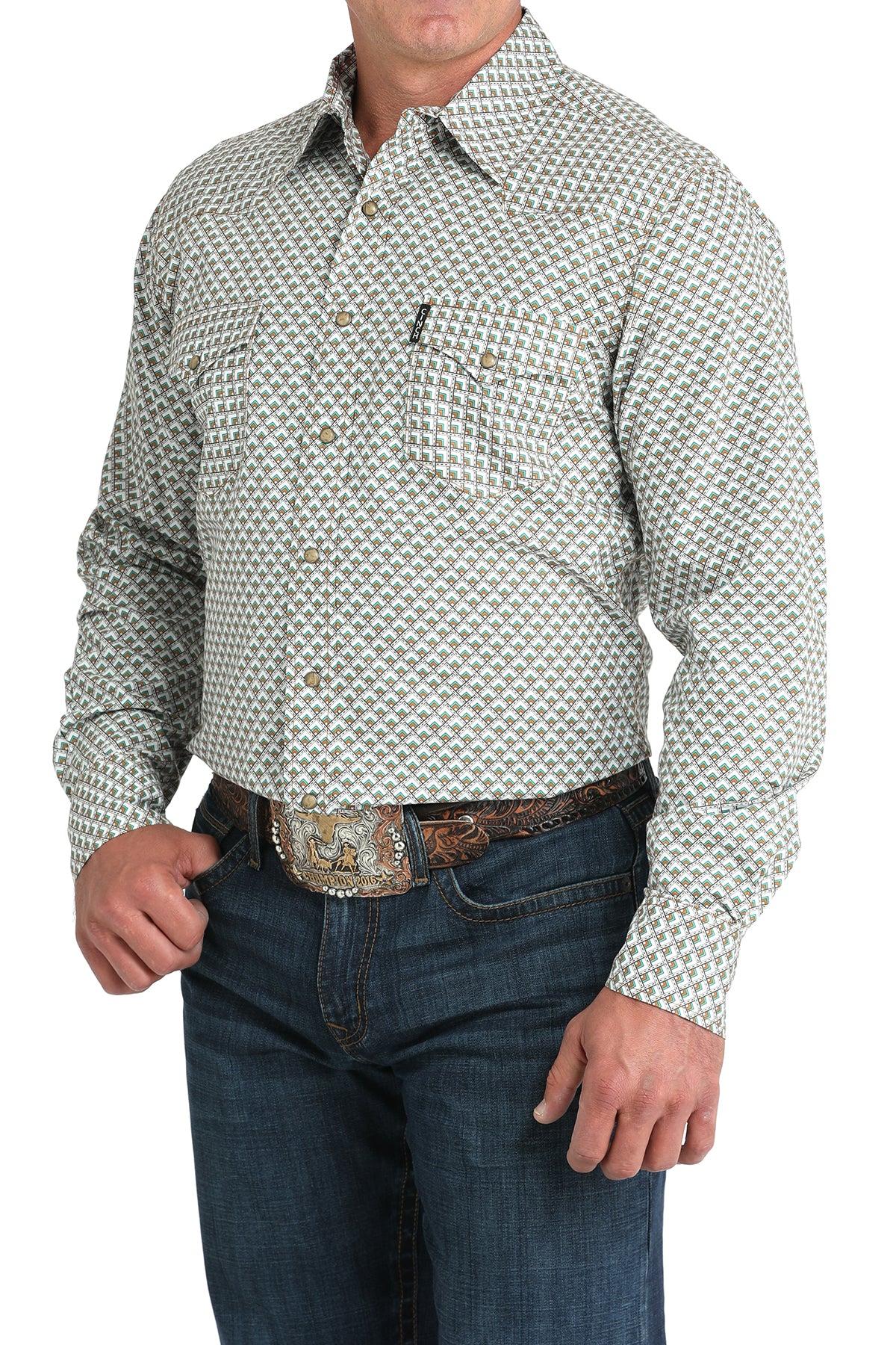Man wearing a long sleeve button-down shirt in white, with jeans and a belt