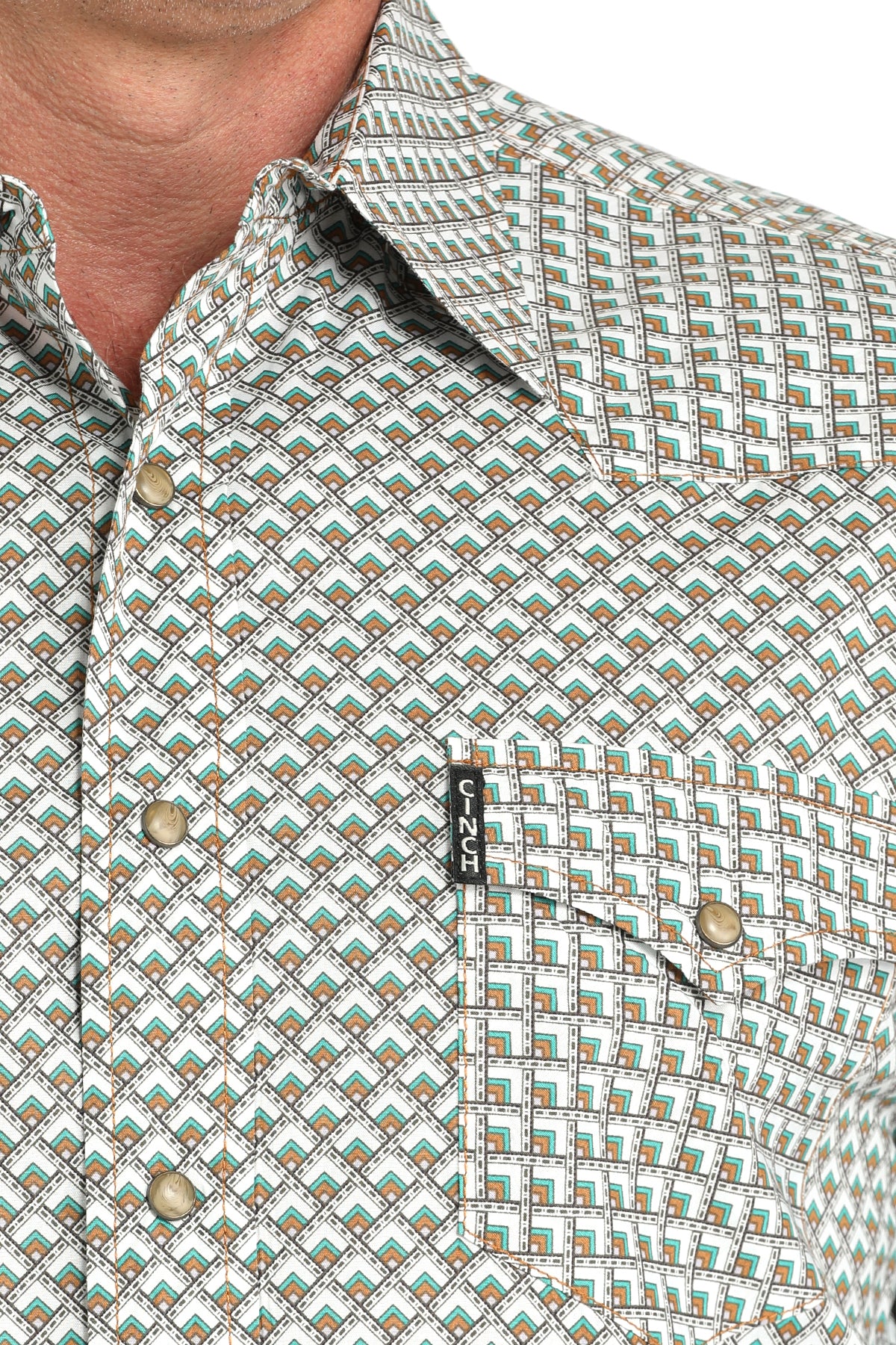 Close-up of a man wearing a long sleeve button-down shirt in white