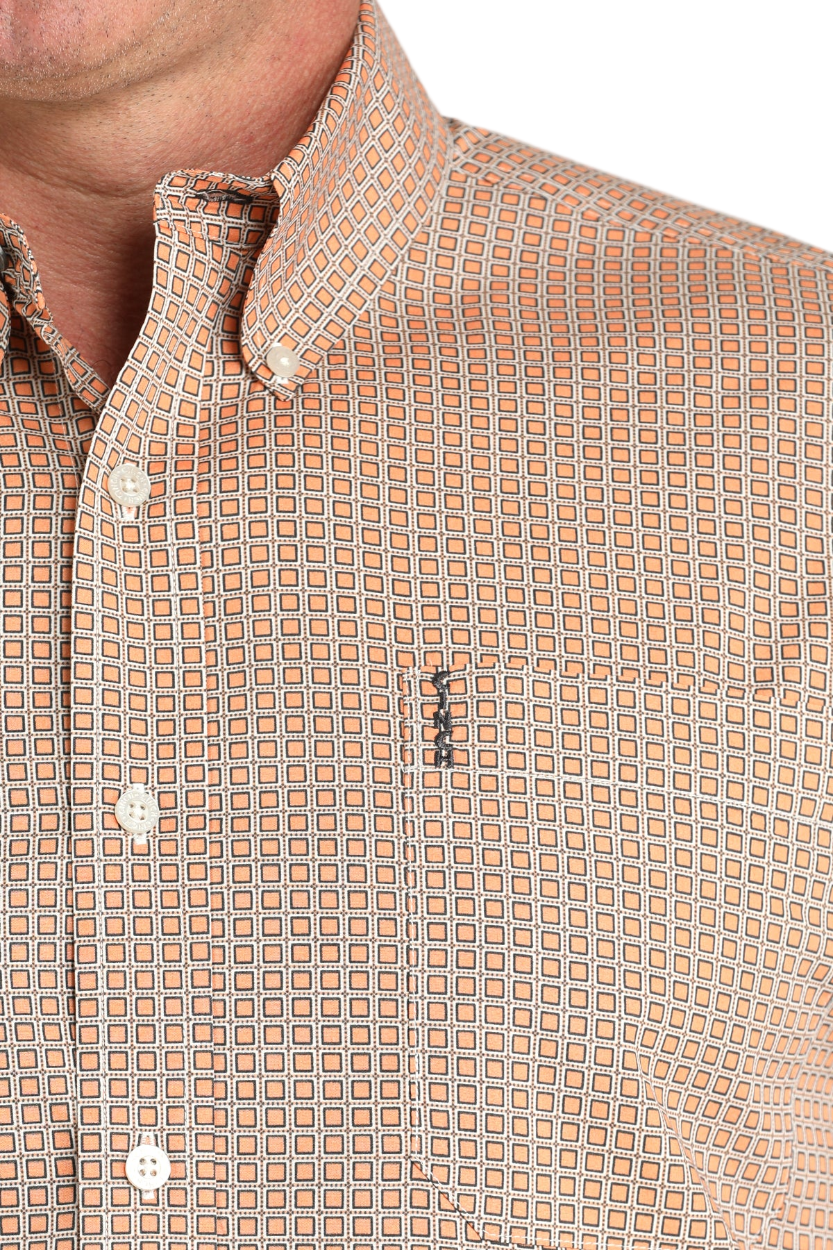 Close-up of a man wearing a patterned beige long sleeve button-down shirt on a transparent background