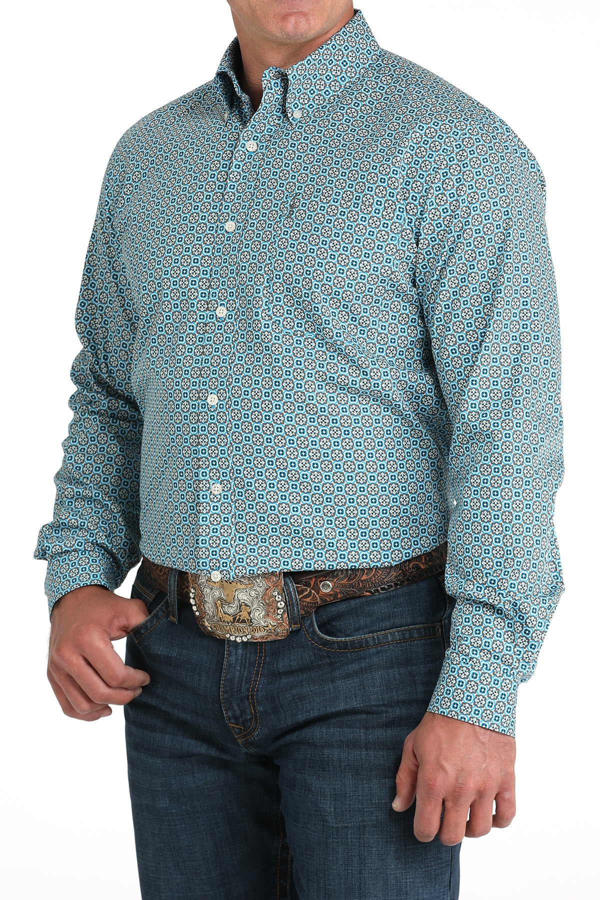 Man wearing a patterned blue shirt and jeans on a white background