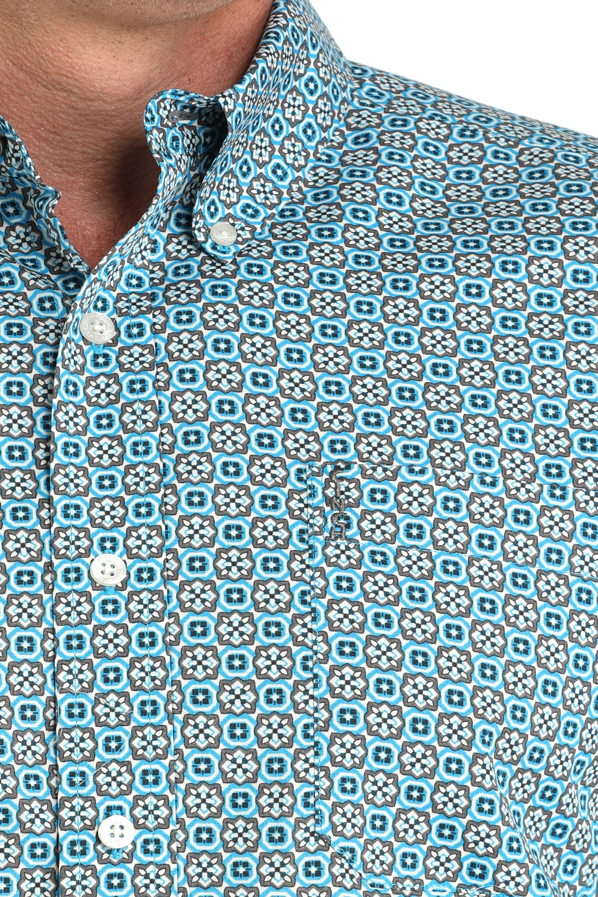 Close-up of a patterned shirt with blue and gray geometric design