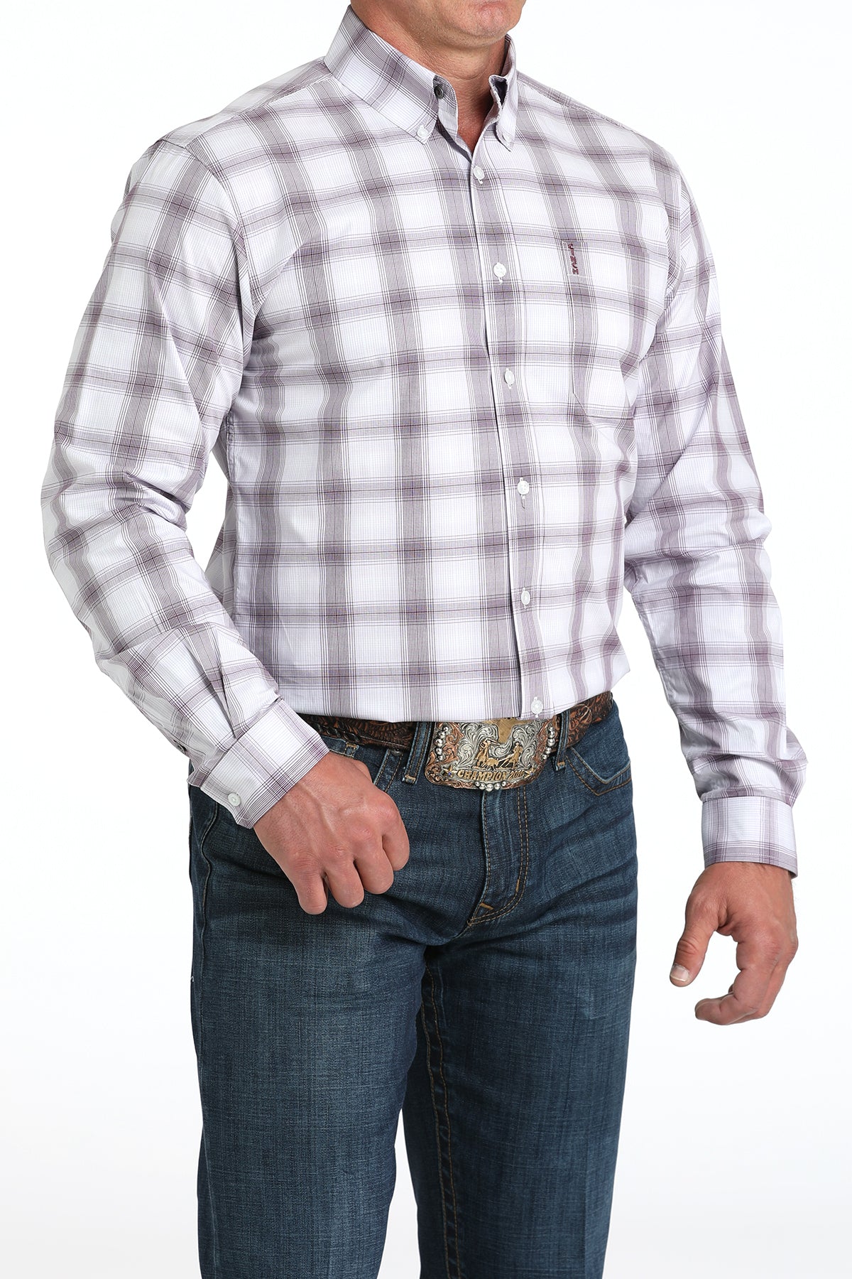 Man wearing a white plaid long sleeve button-down with jeans and a belt
