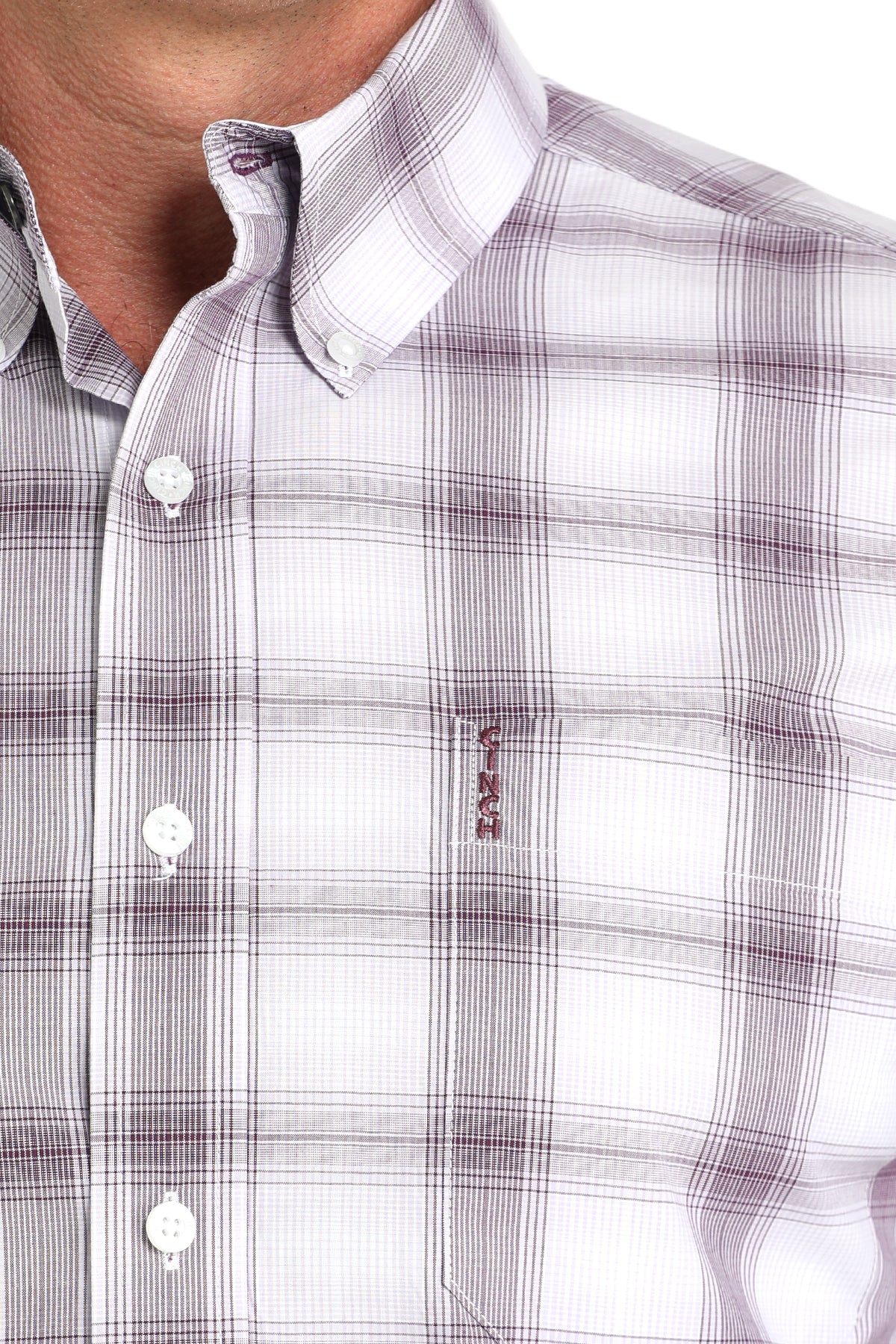 Close-up of a man wearing a white plaid long sleeve button-down