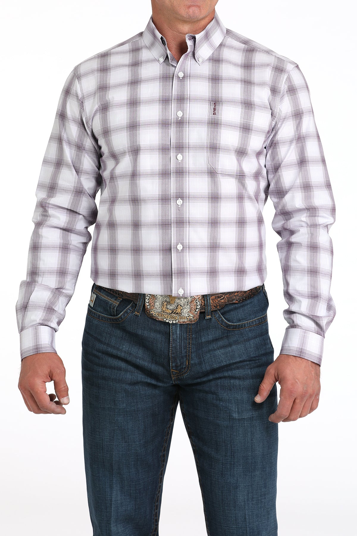 Man wearing a white plaid long sleeve button-down with jeans and a belt